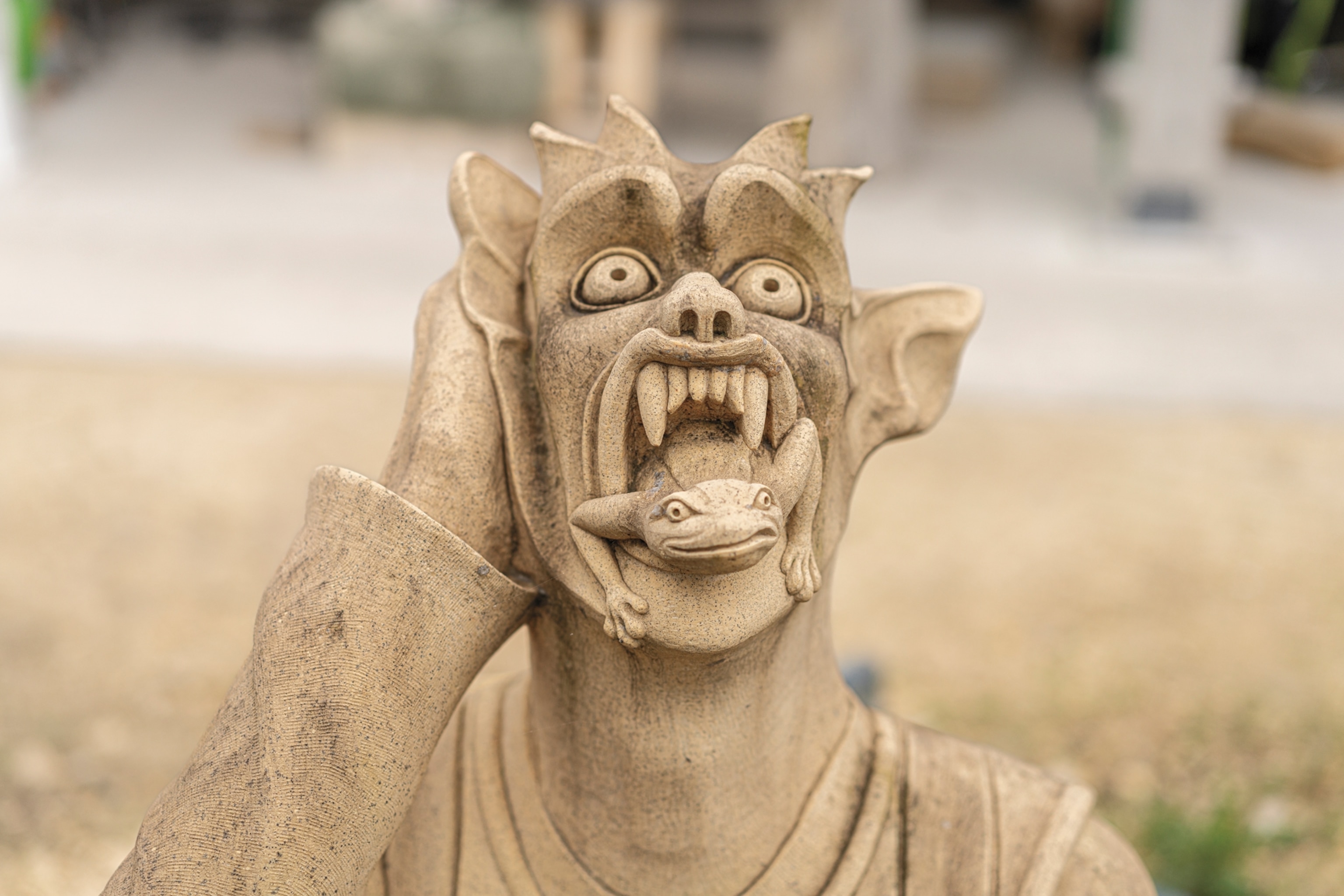 A grotesque depicting a monster with a frog emerging from its open mouth.