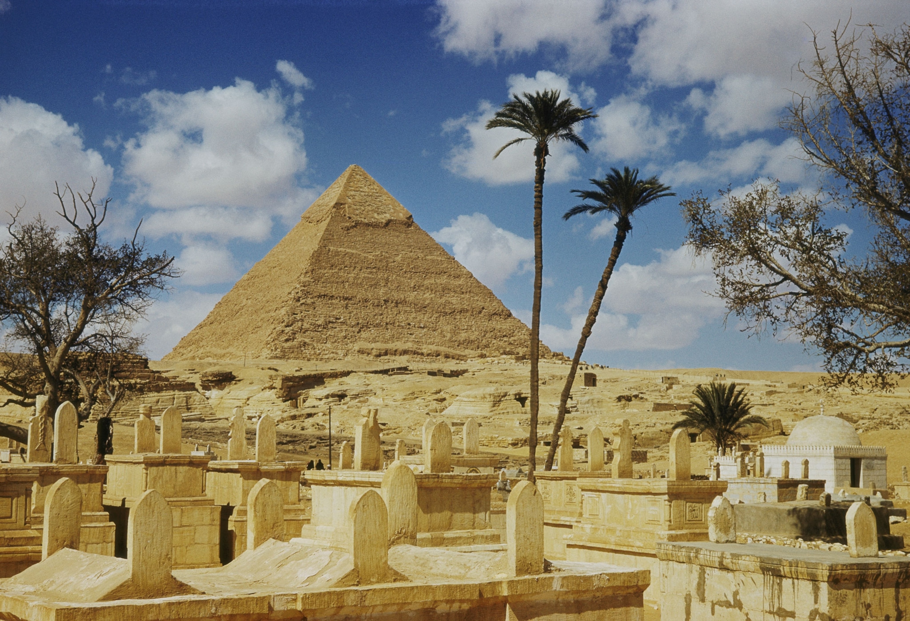 pyramids seen behind an Arab cemetery.