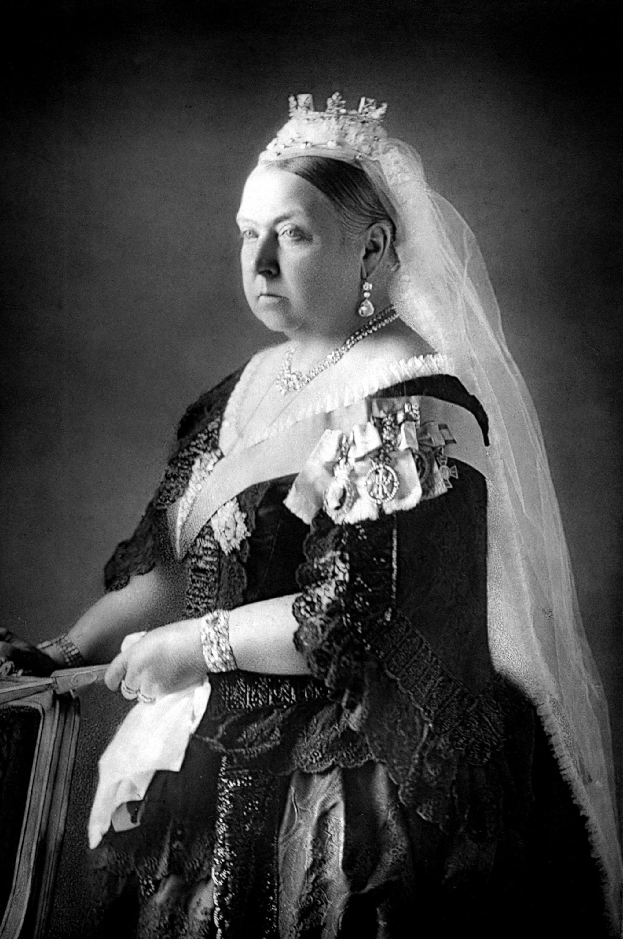 A black and white portrait of a woman wearing a crown