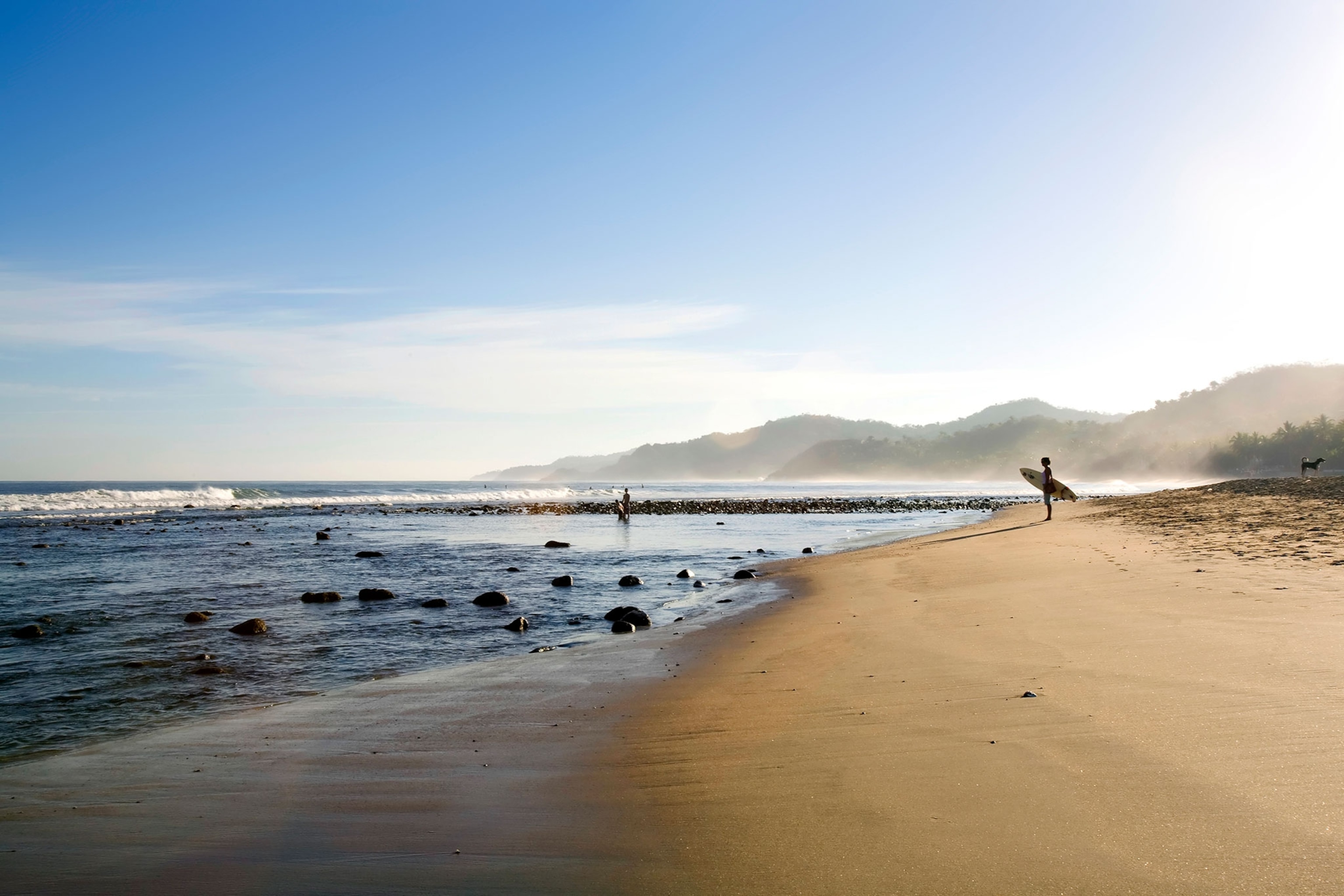 a surfer on the beach in Sayulita, Mexico