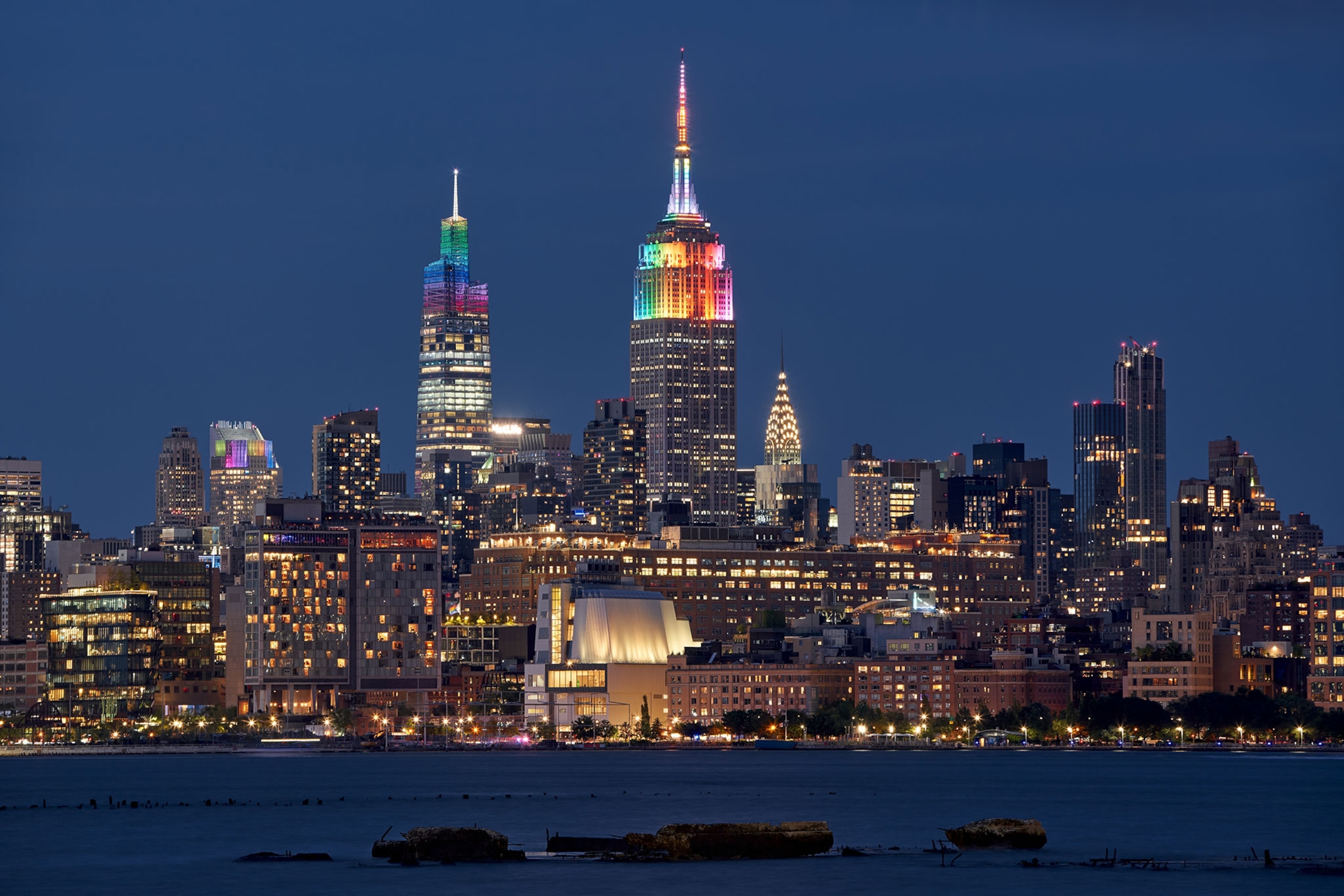 New York City skyline with One Venderbilt skyscrapers illuminated with rainbow colors