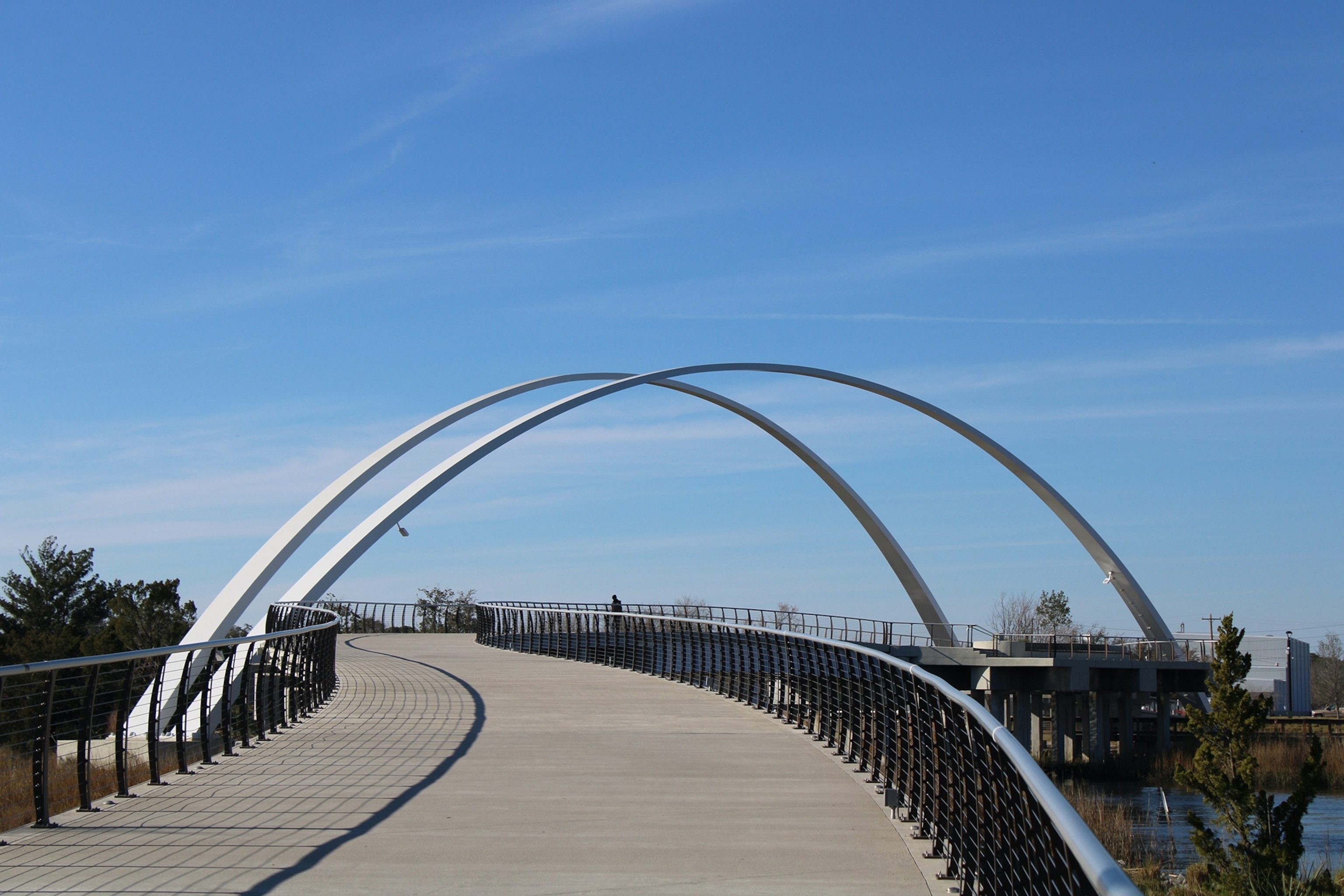 The walkway of a bridge with double arches.