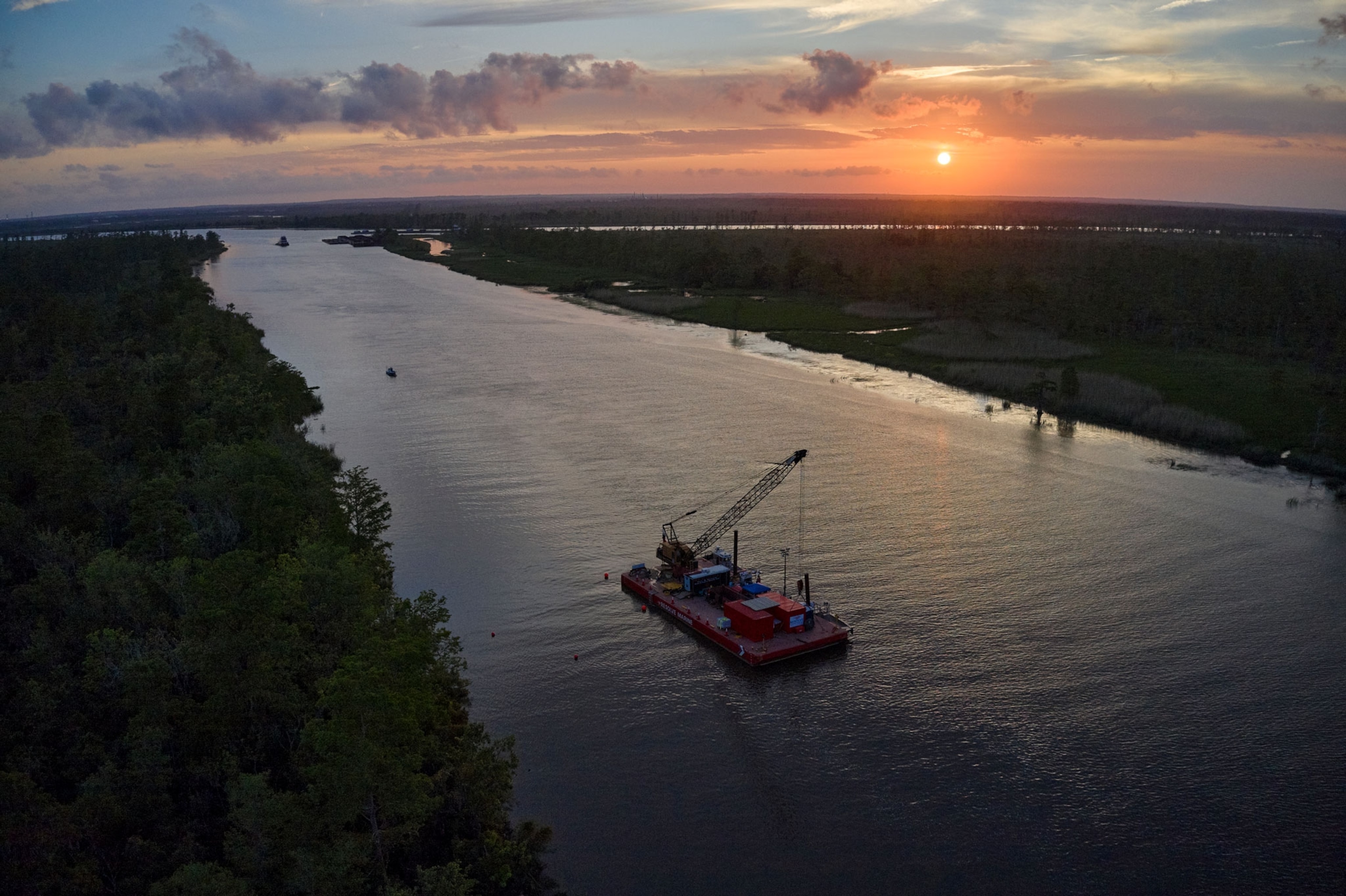 The sun sets on the site of Clotilda's sinking in the Mobile River.