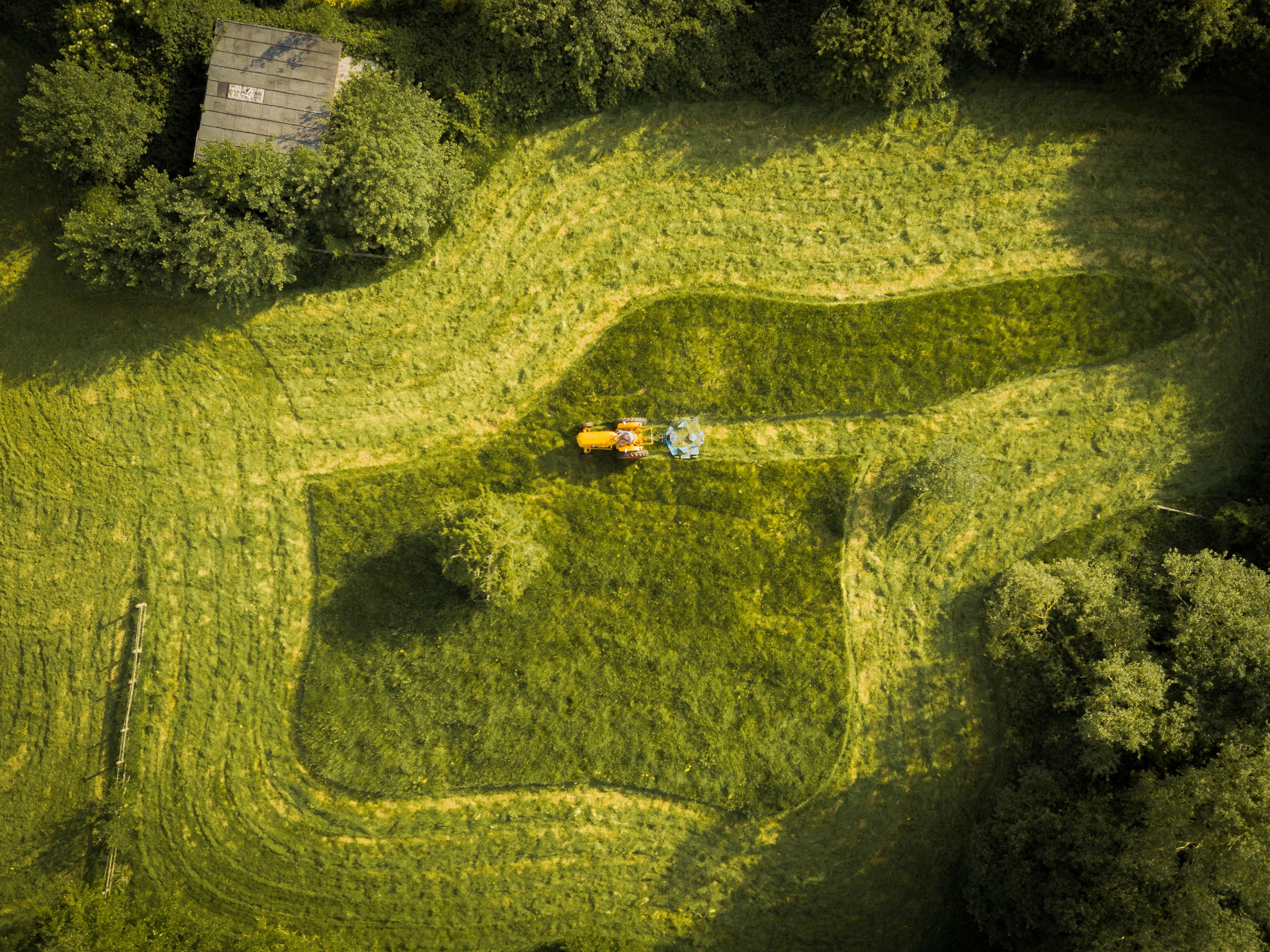 a tractor mowing the lawn seen from above
