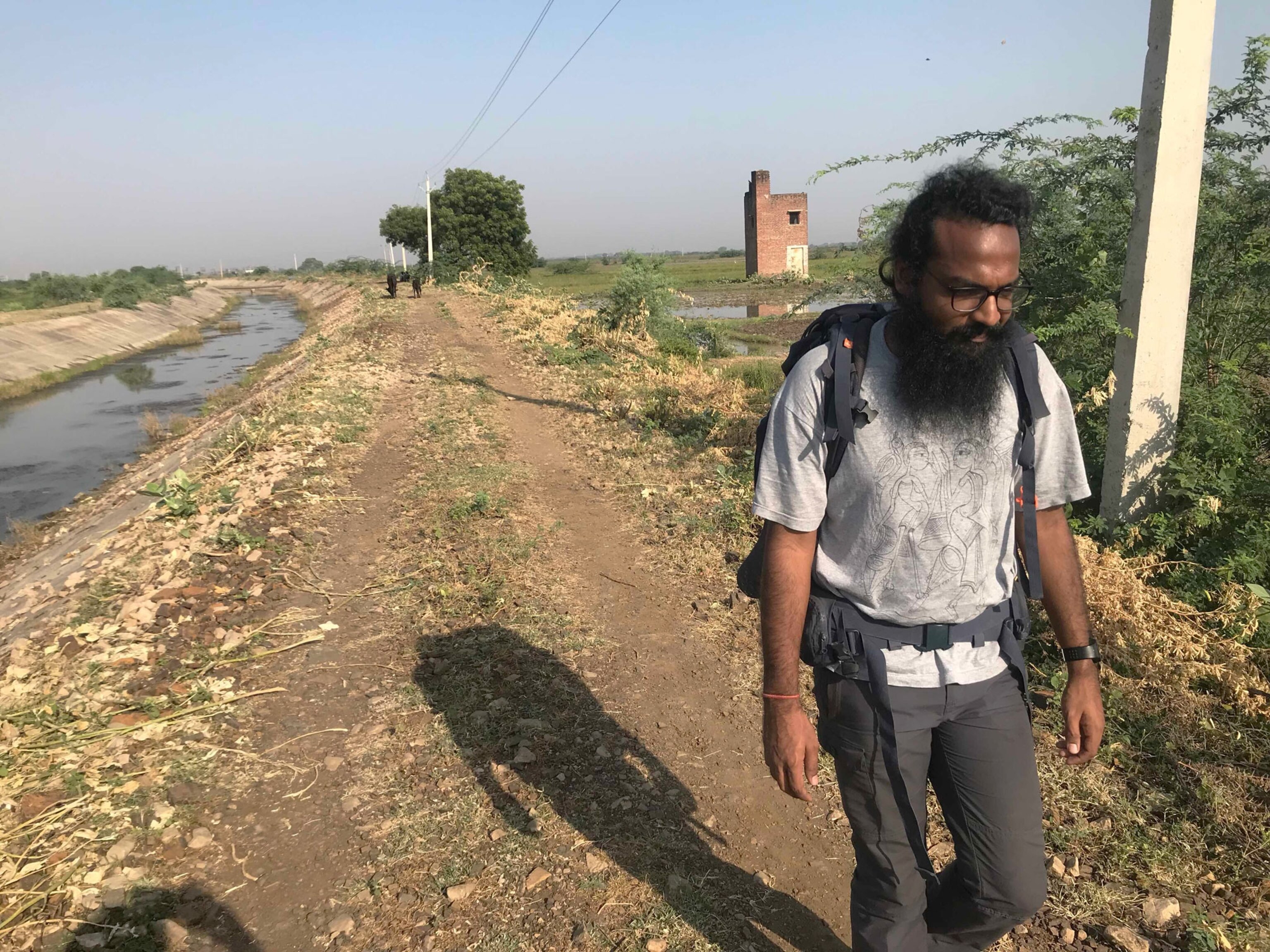 a man walking along a canal