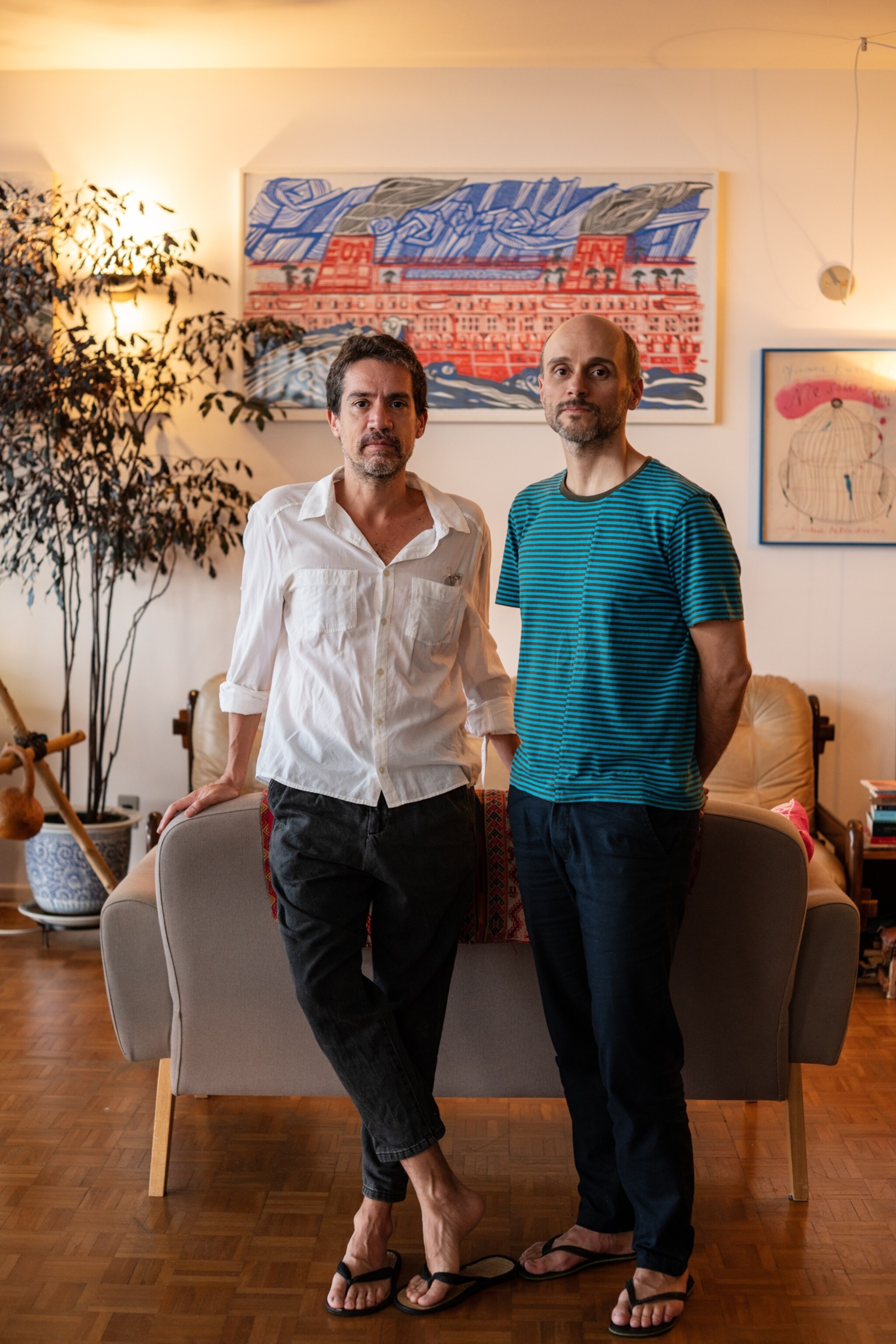 two men standing inside their home