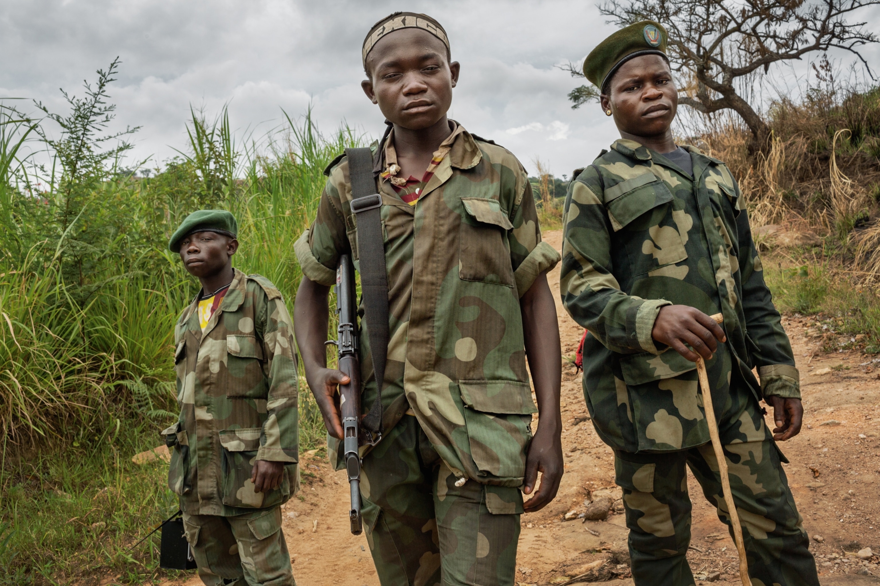 children soldiers patrolling a gold min in Bavi