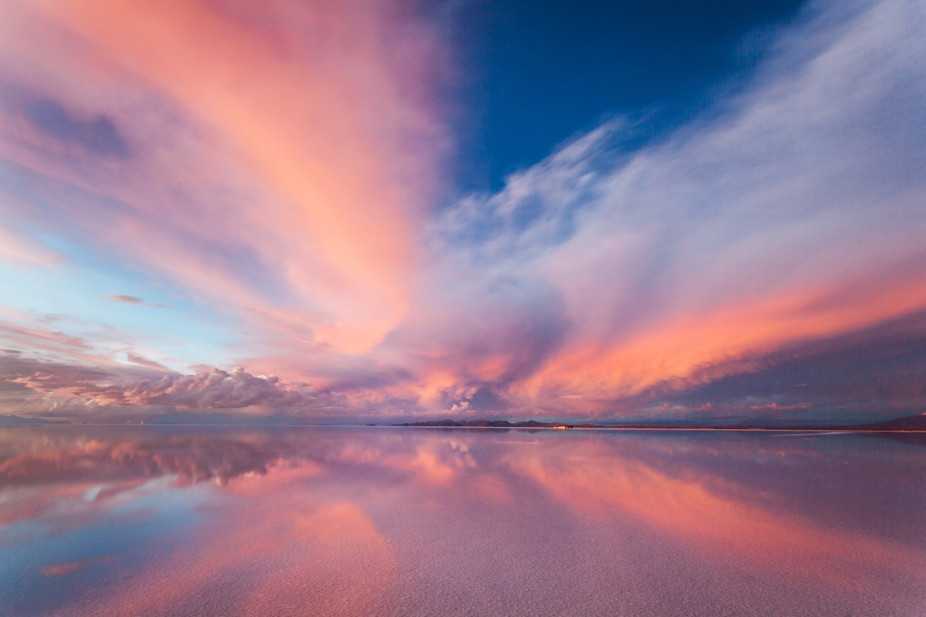 Color sunset reflects off of the water creating a perfect mirror image above and below