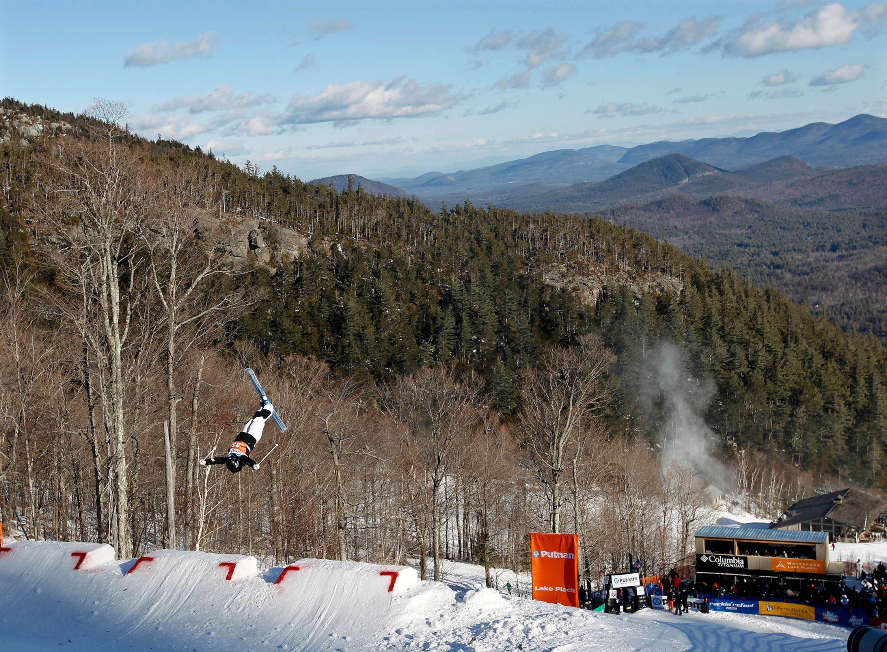 A woman on ski's can be seen mid air.