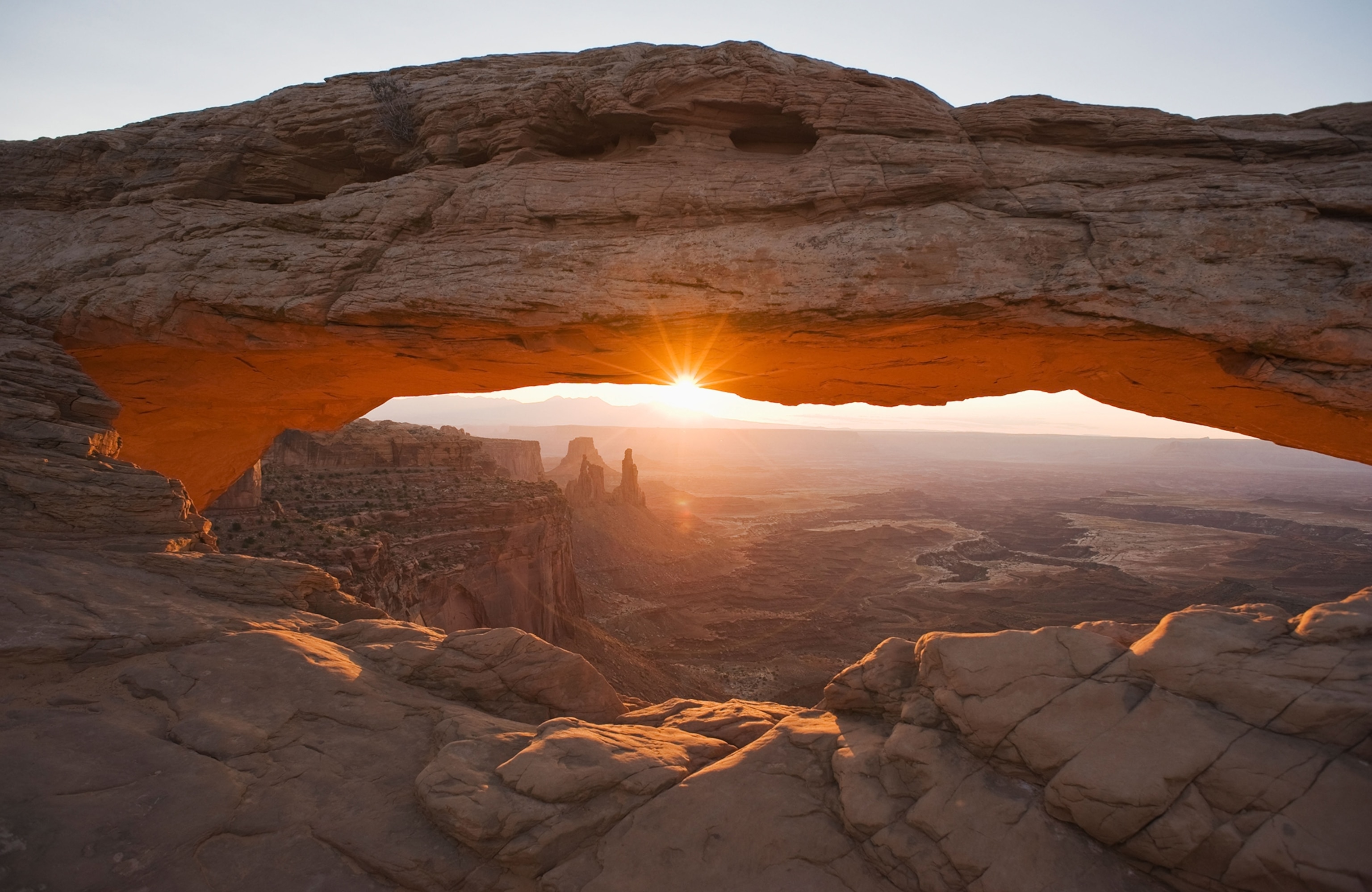 sun shining through Mesa Arch, Canyonlands National Park, Utah