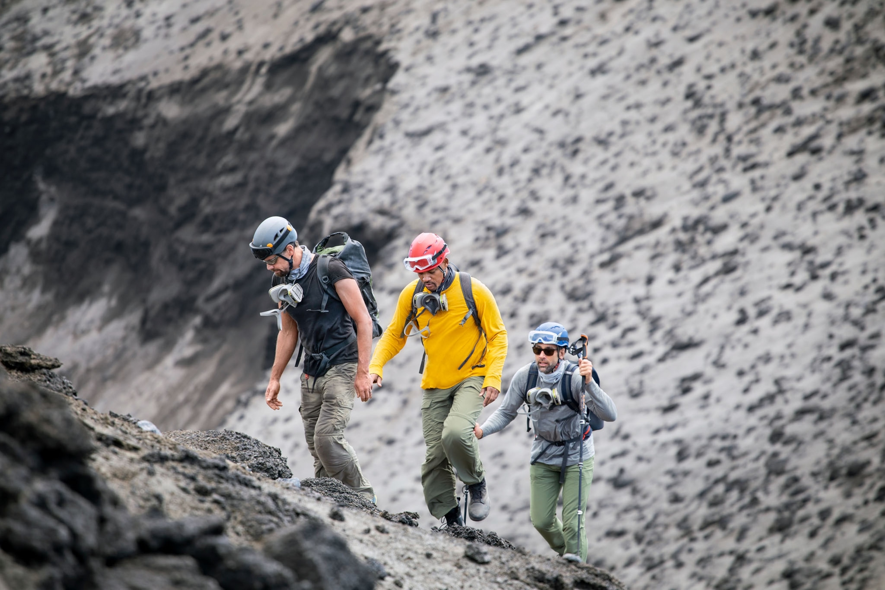 Picture of three men descending into volcano.