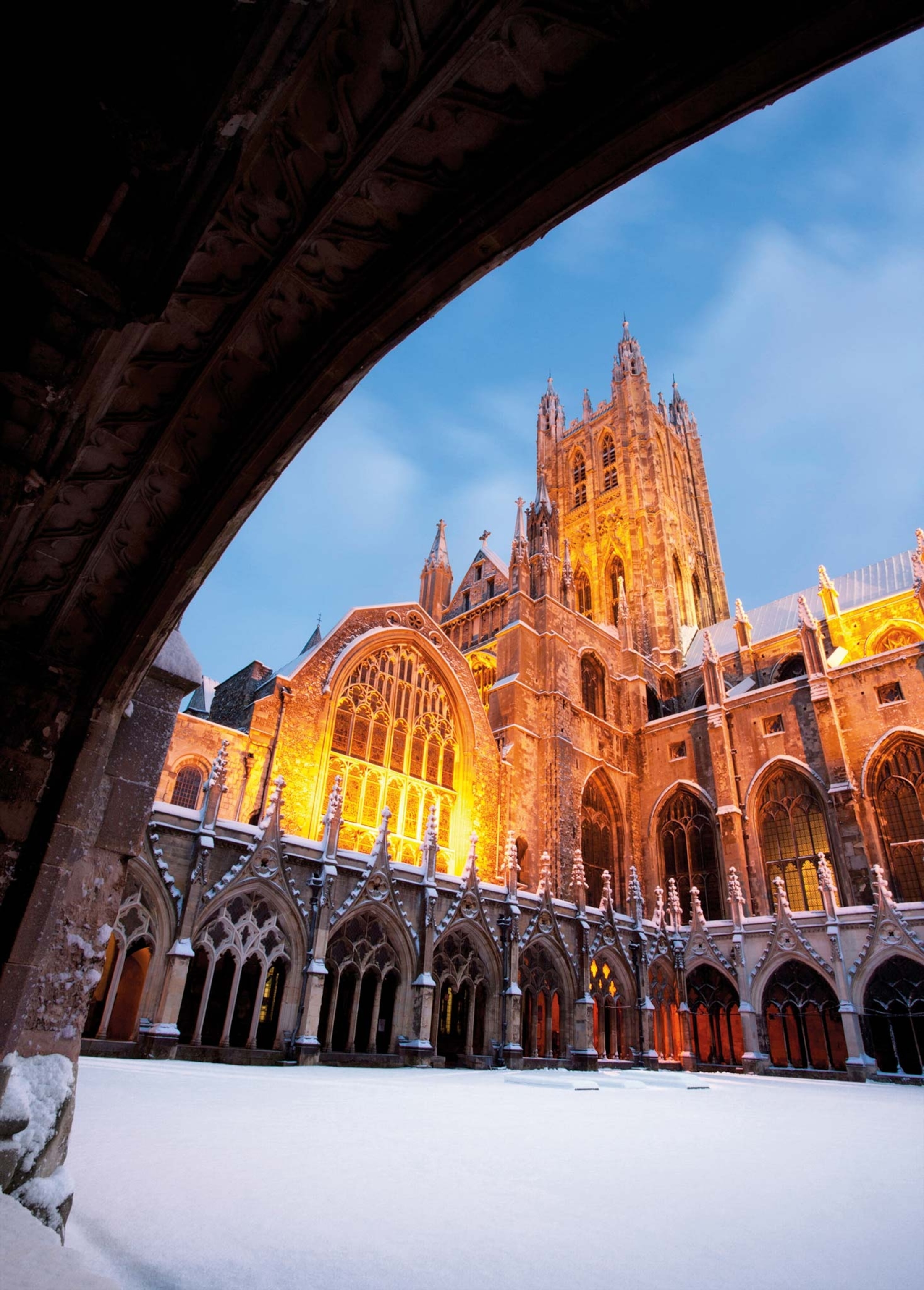 A view of the Canterbury Cathedral in the winter with snow on the ground