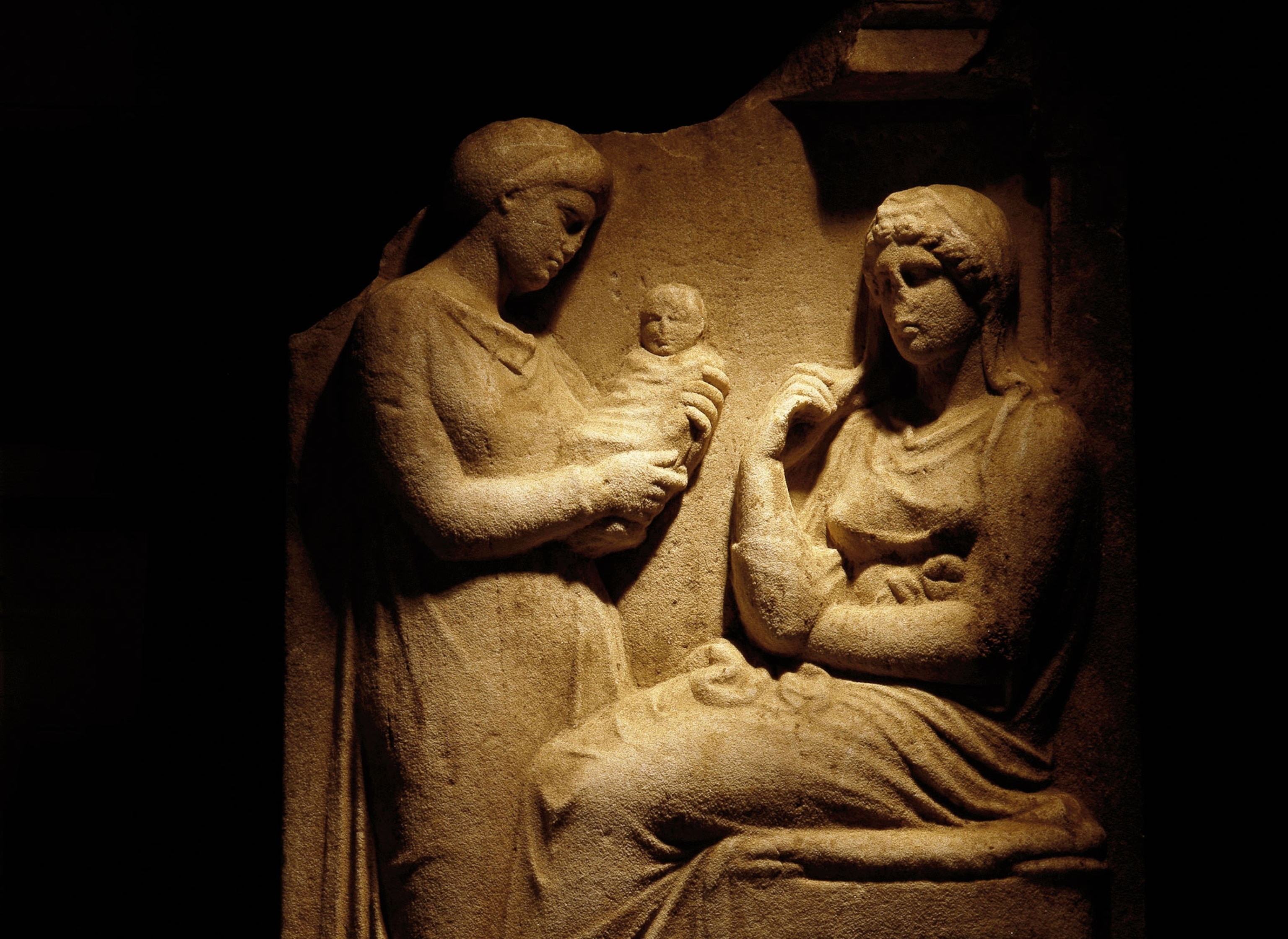 a Greek funerary stele depicting a mother and another woman holding a baby