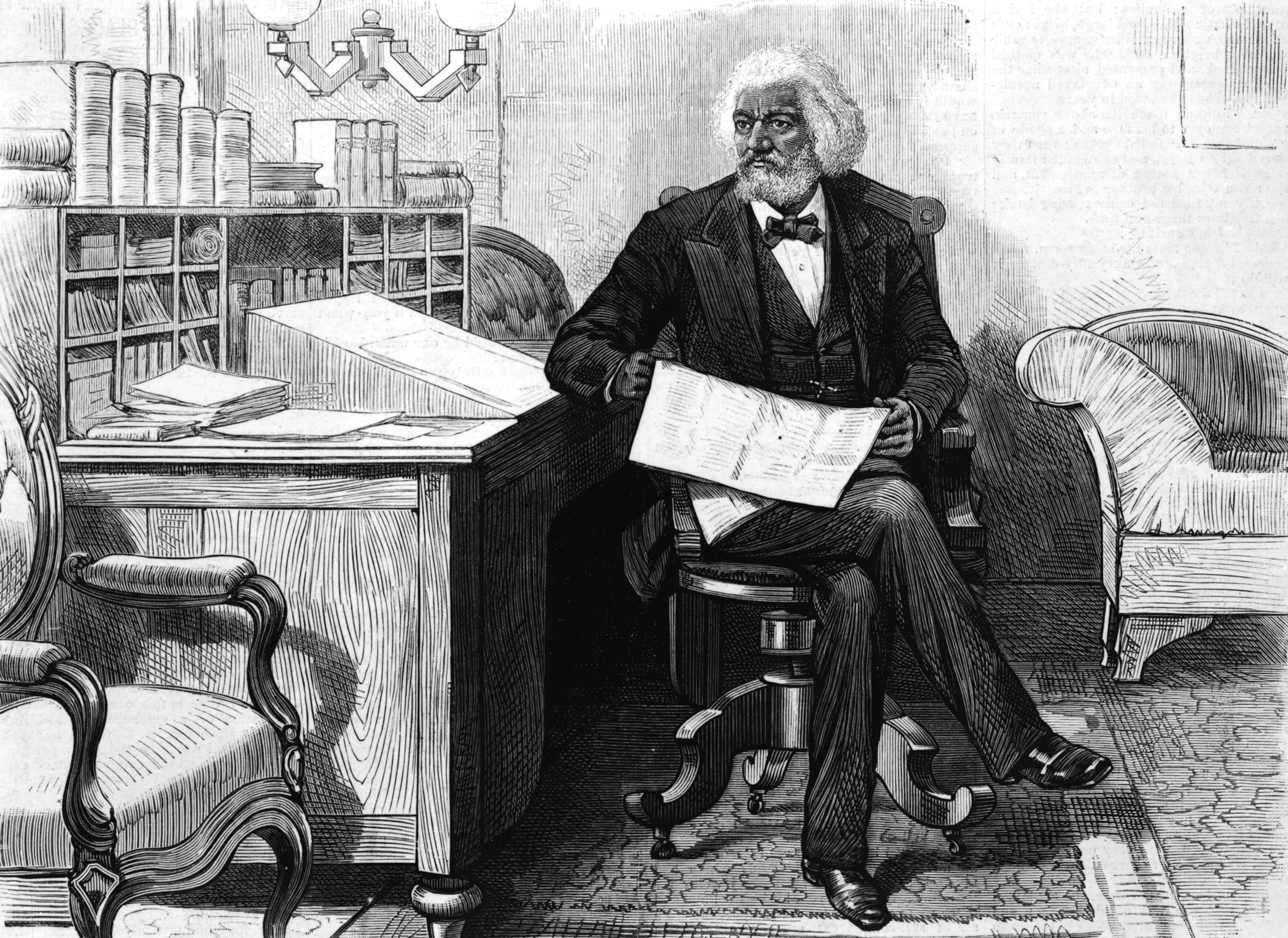 Frederick Douglass sits at a desk while holding a newspaper