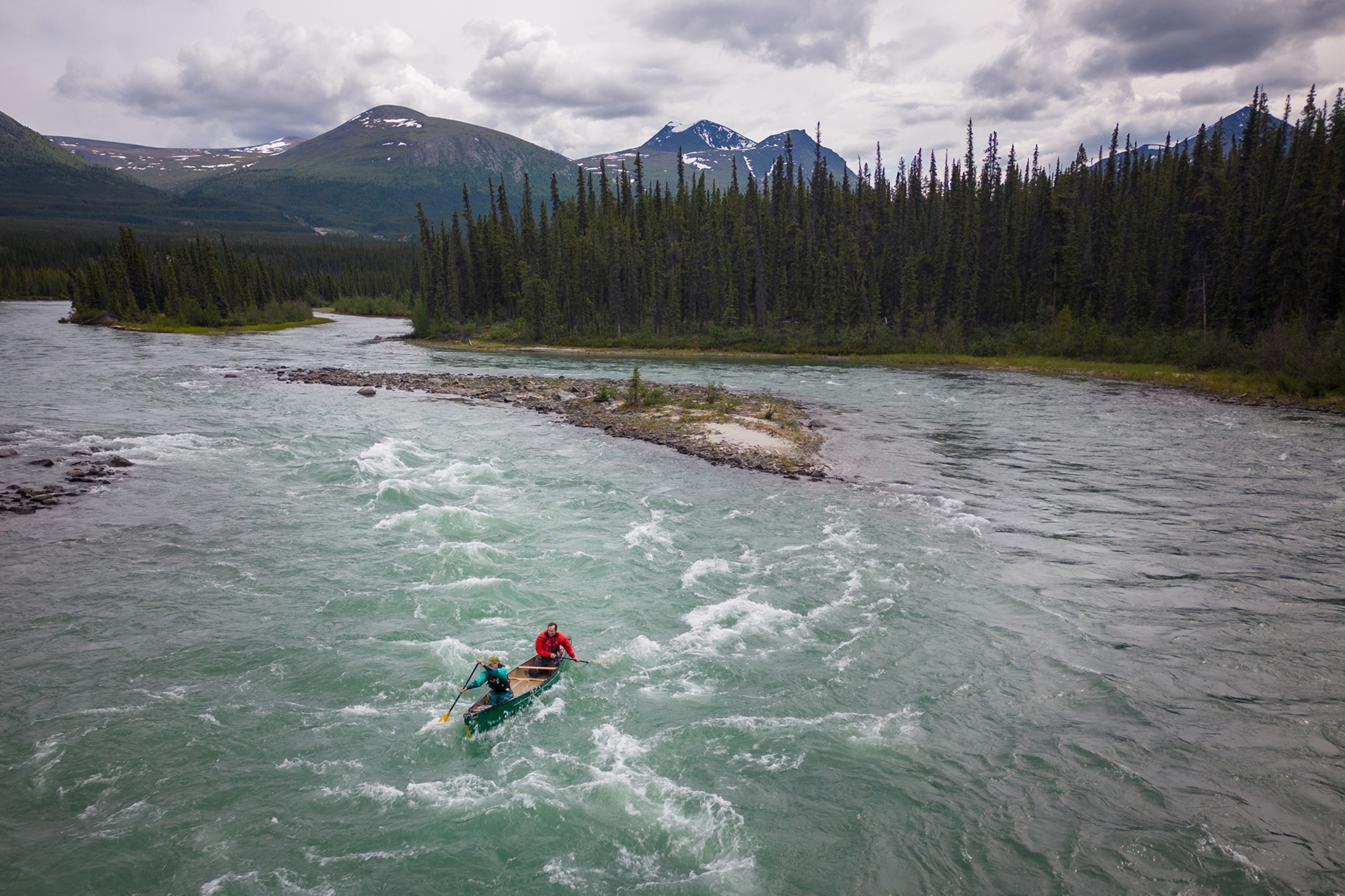 People navigate their canoes on the Takhini river on a popular section of rapids named the jaws.