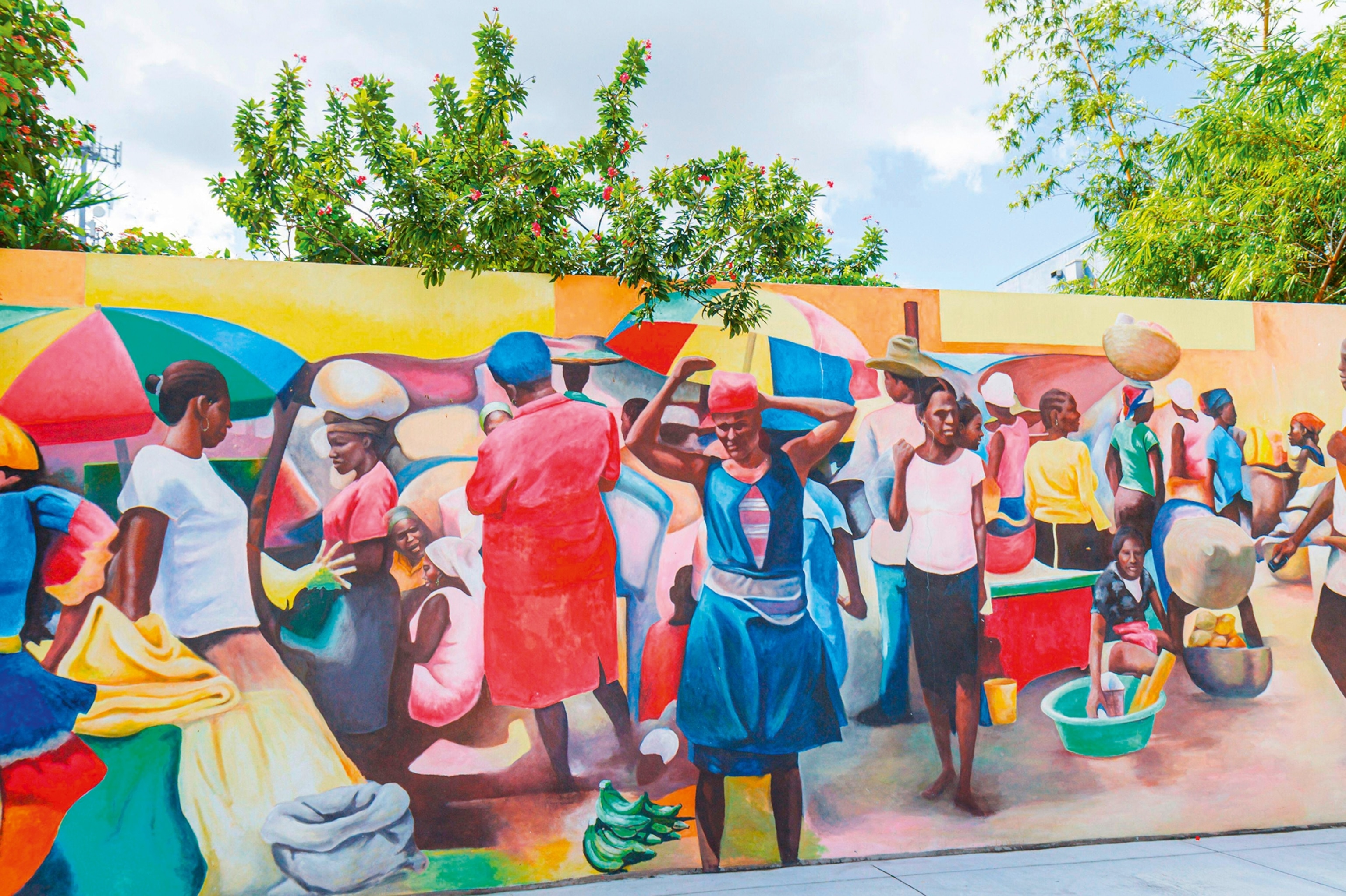 A colourful, street-side mural depicting scenes from Black American history and heritage.