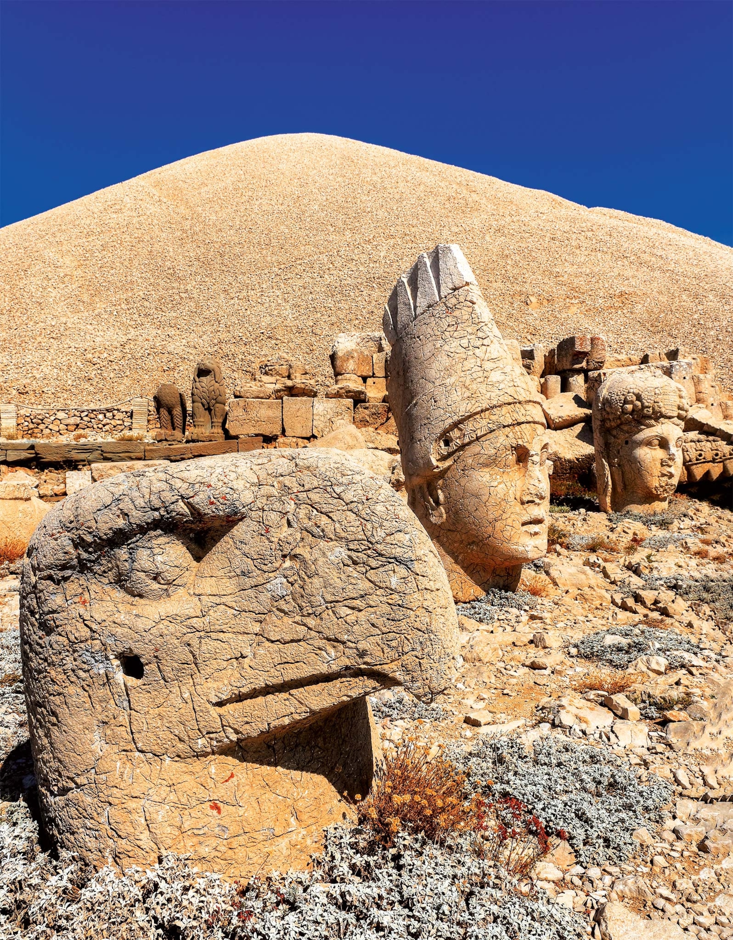 A view of the west terrace at Mount Nemrut has the heads in foreground and remains of the colossal statues in background