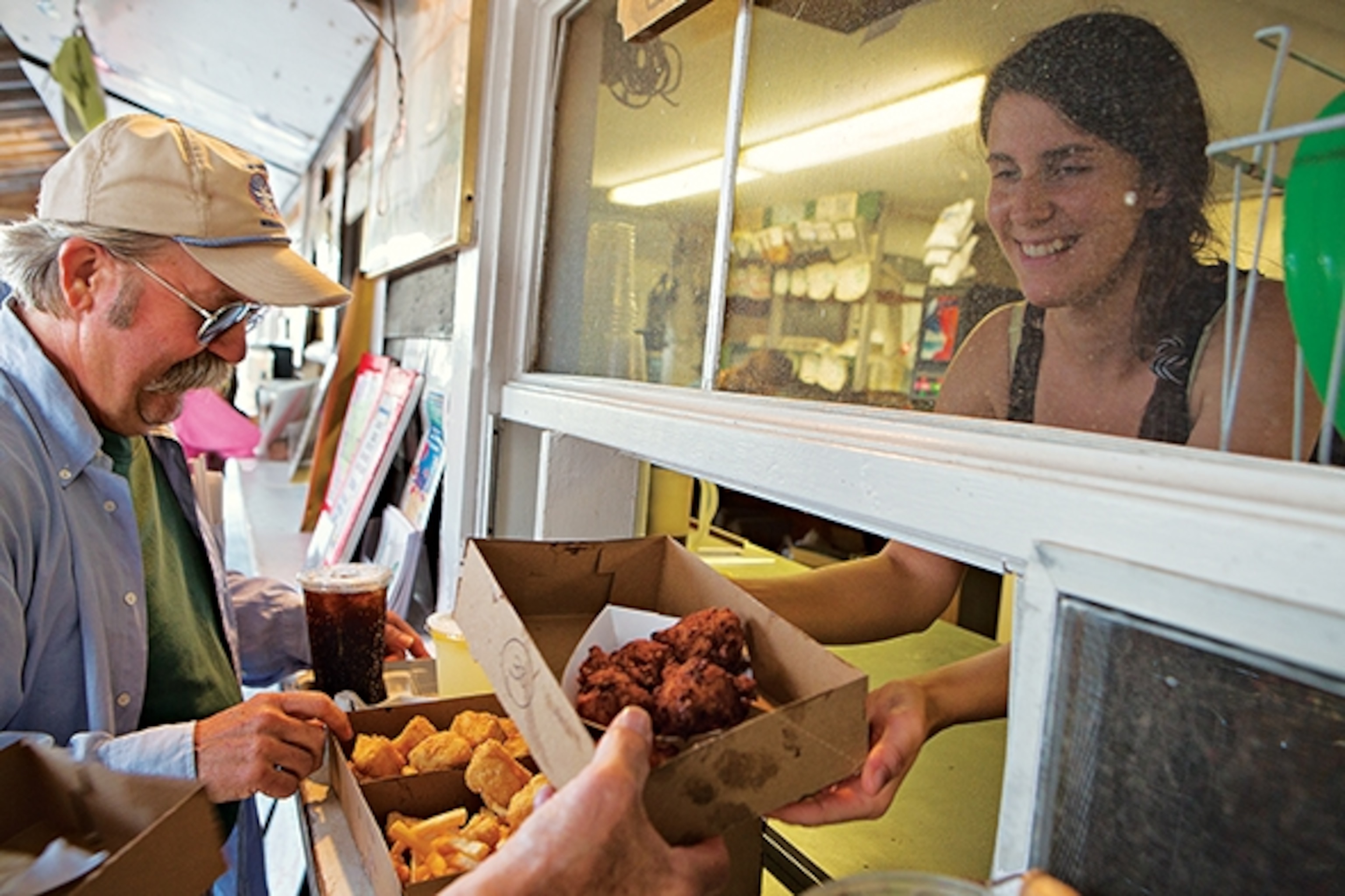 Liam's Seafood & Grill  is famous for its onion rings and fried seafood takeaway. Liam, the company namesake, at left.  (Photograph by Amy Toensing)