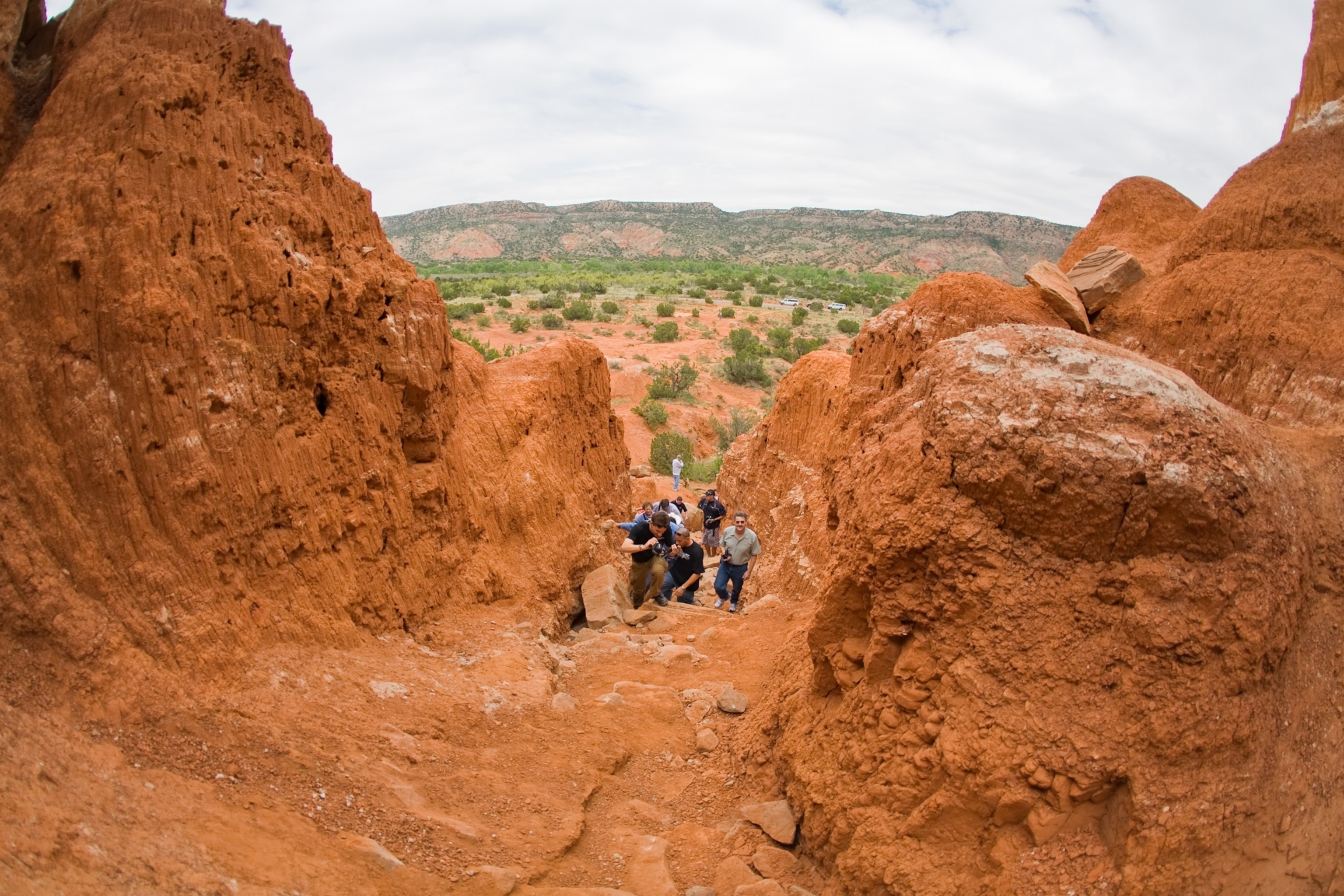 A group of hikers along a trail in Palo Duro canyon.