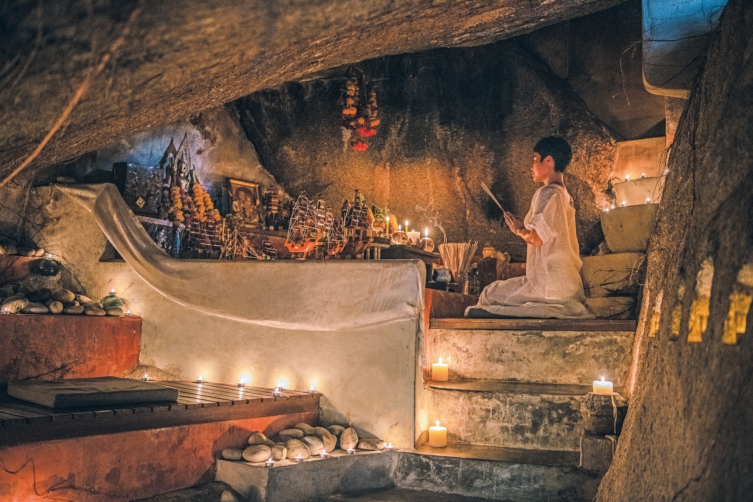 Arjan cave in Thailand, illuminated by candles