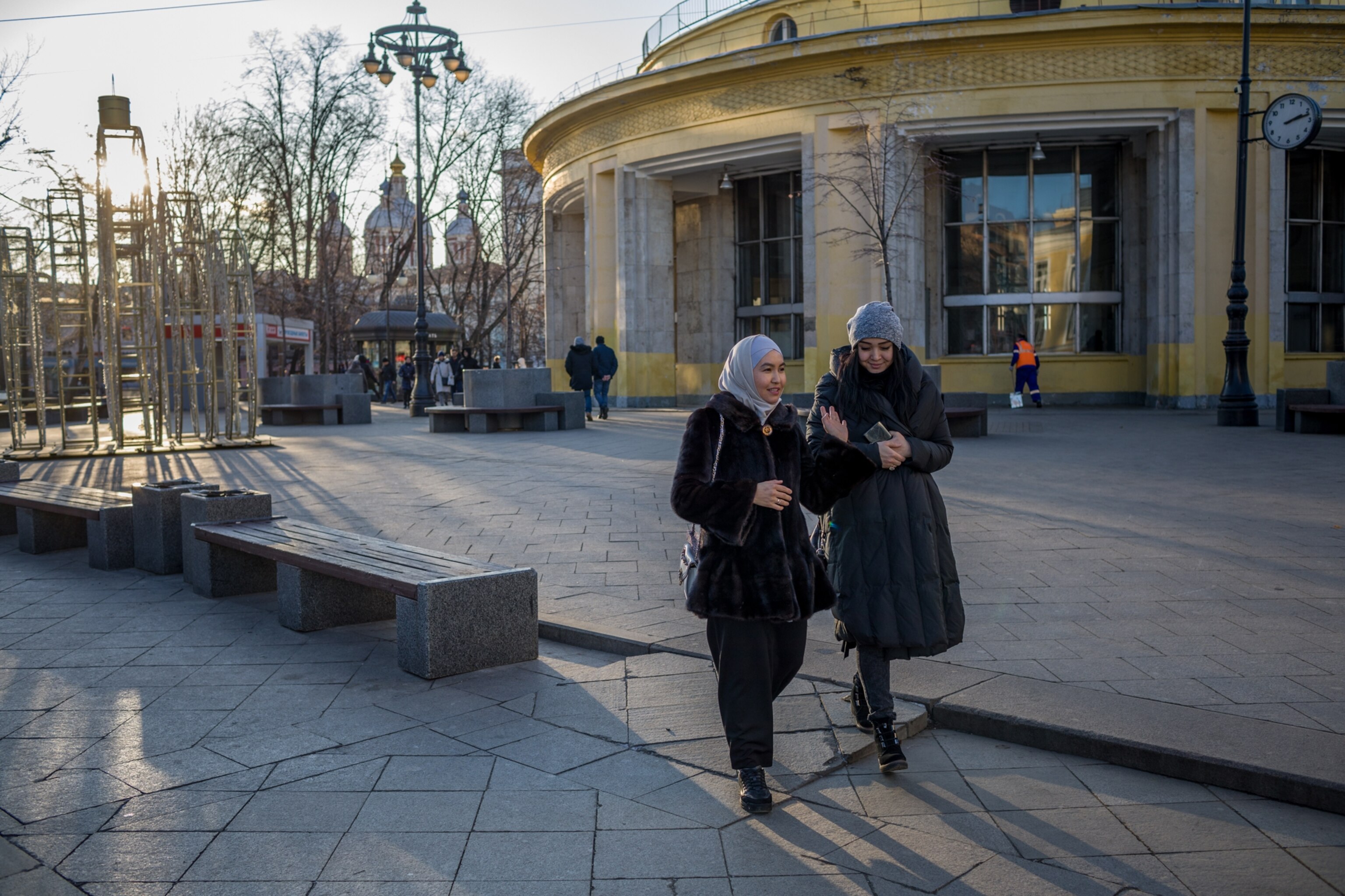 two women walking along a street
