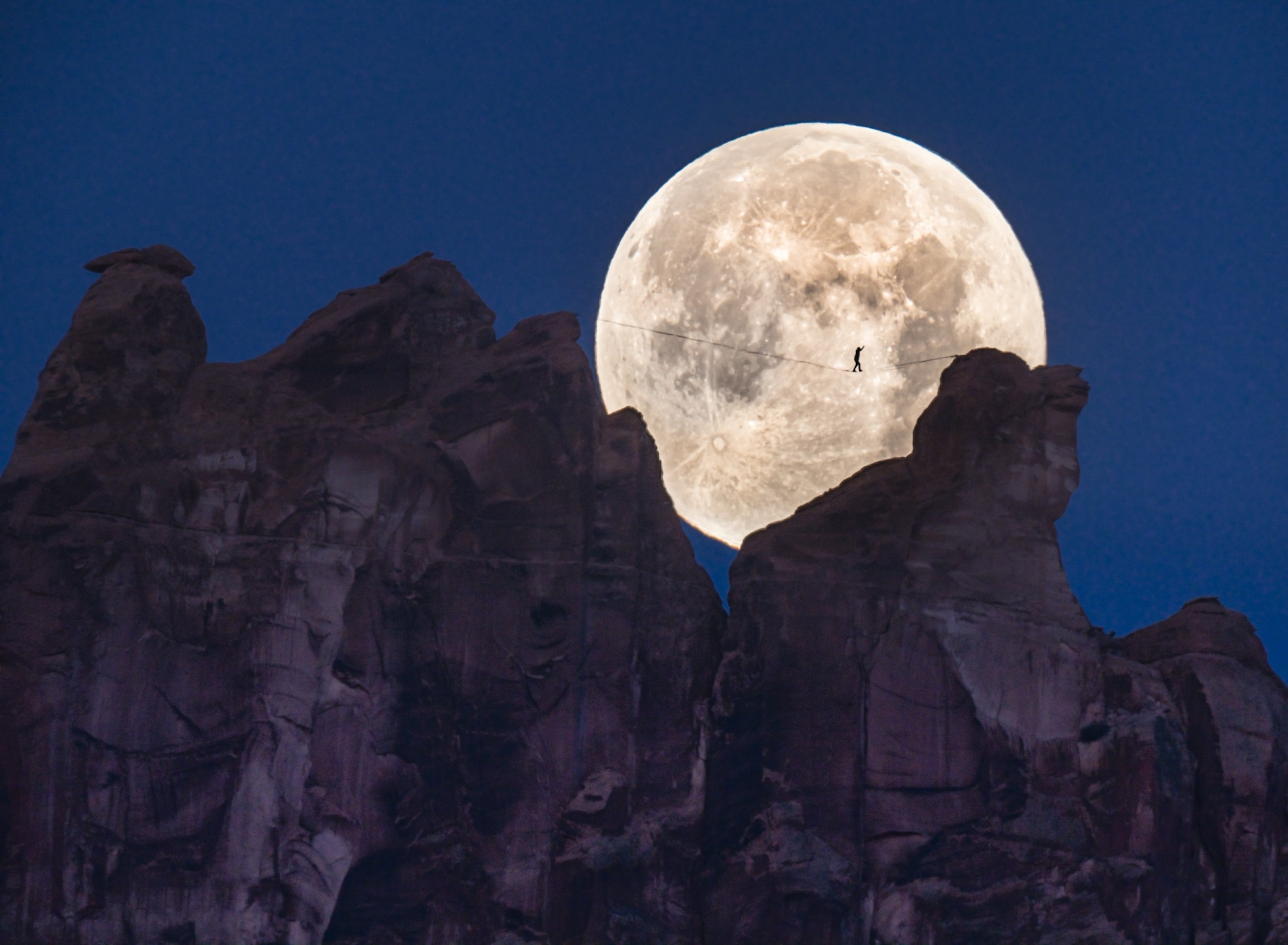 man walks in front of moon