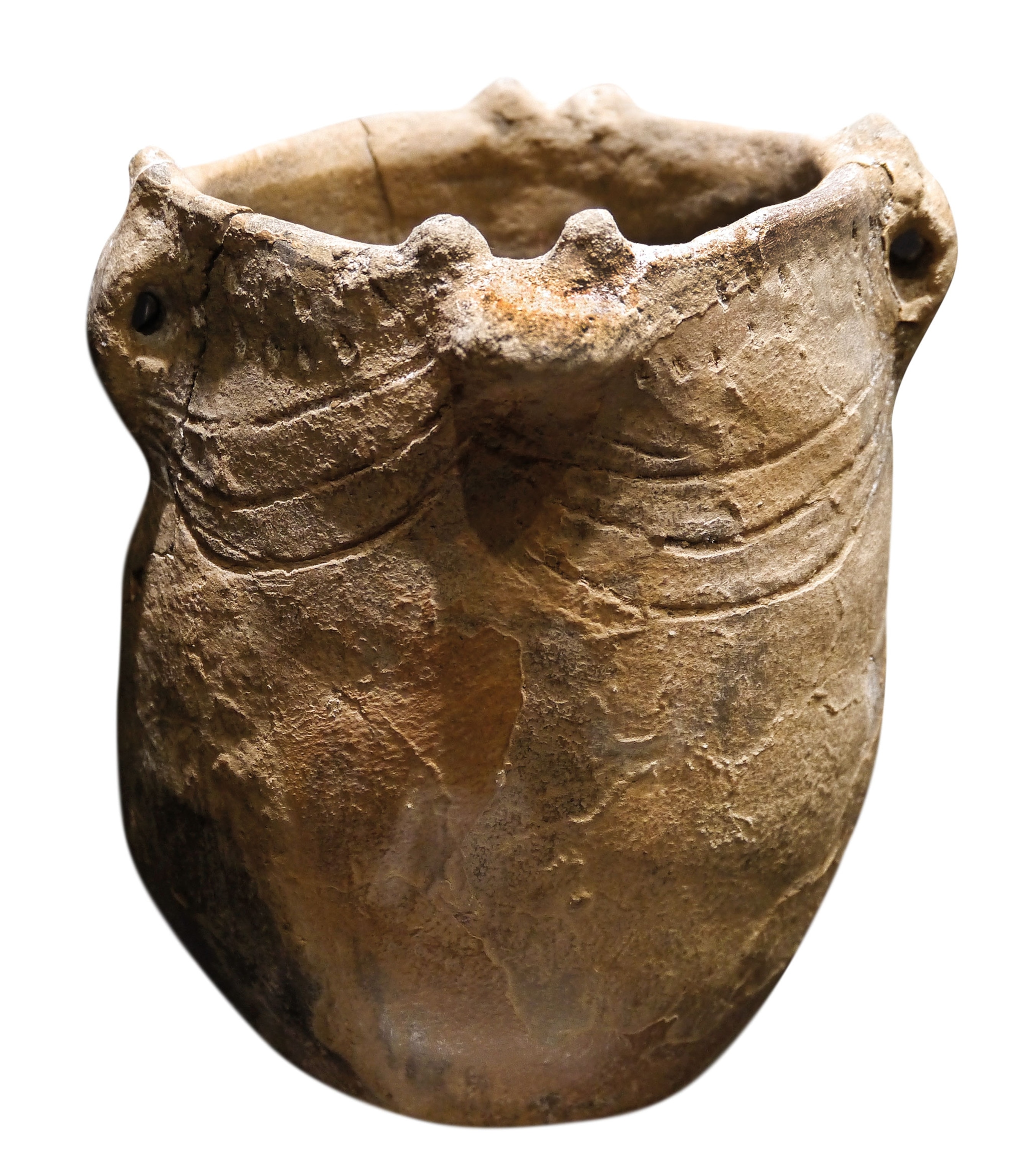 a round vessel with decorative lines around the rim