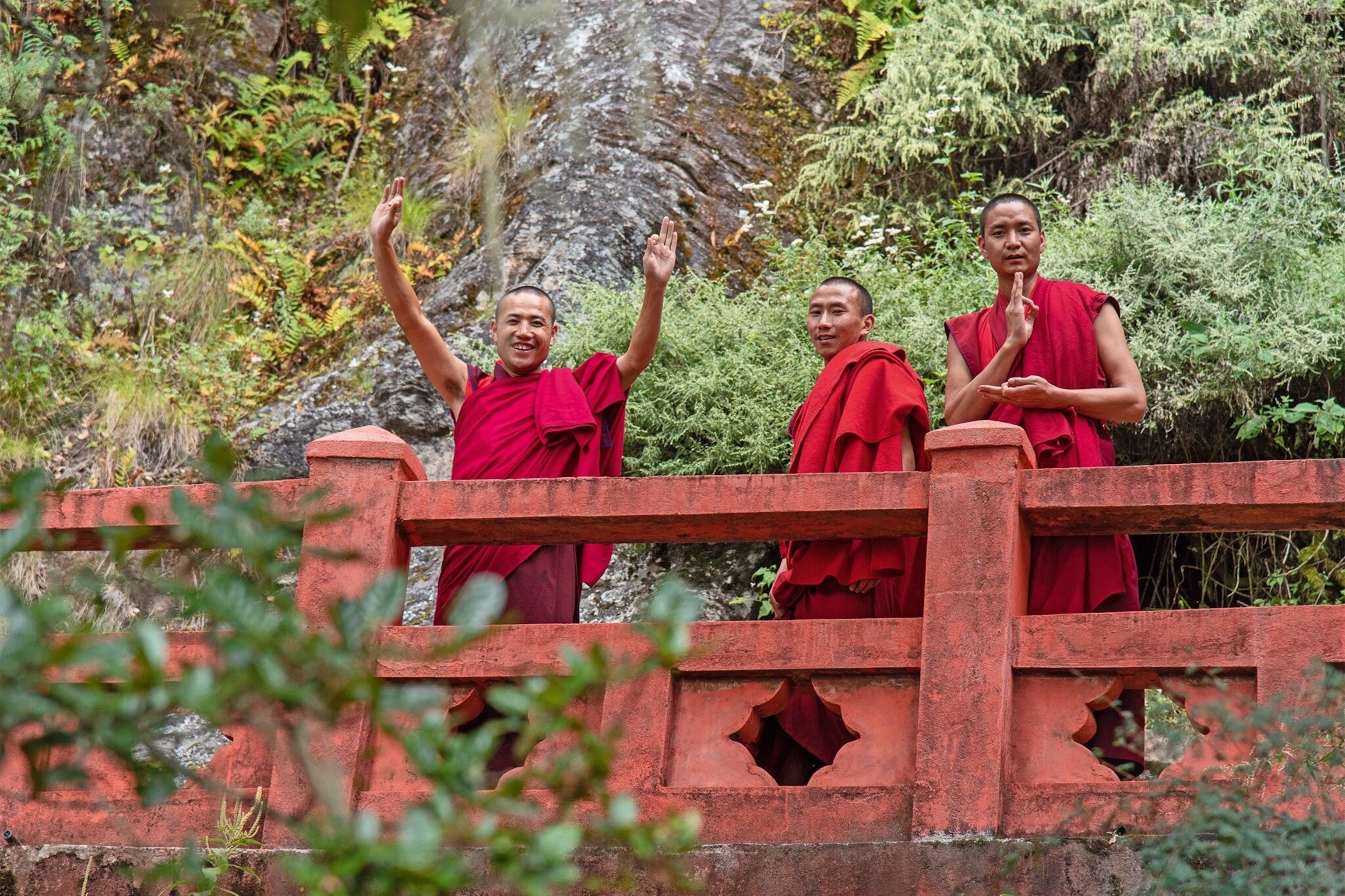 Monks cross a bridge in the Paro Valley.