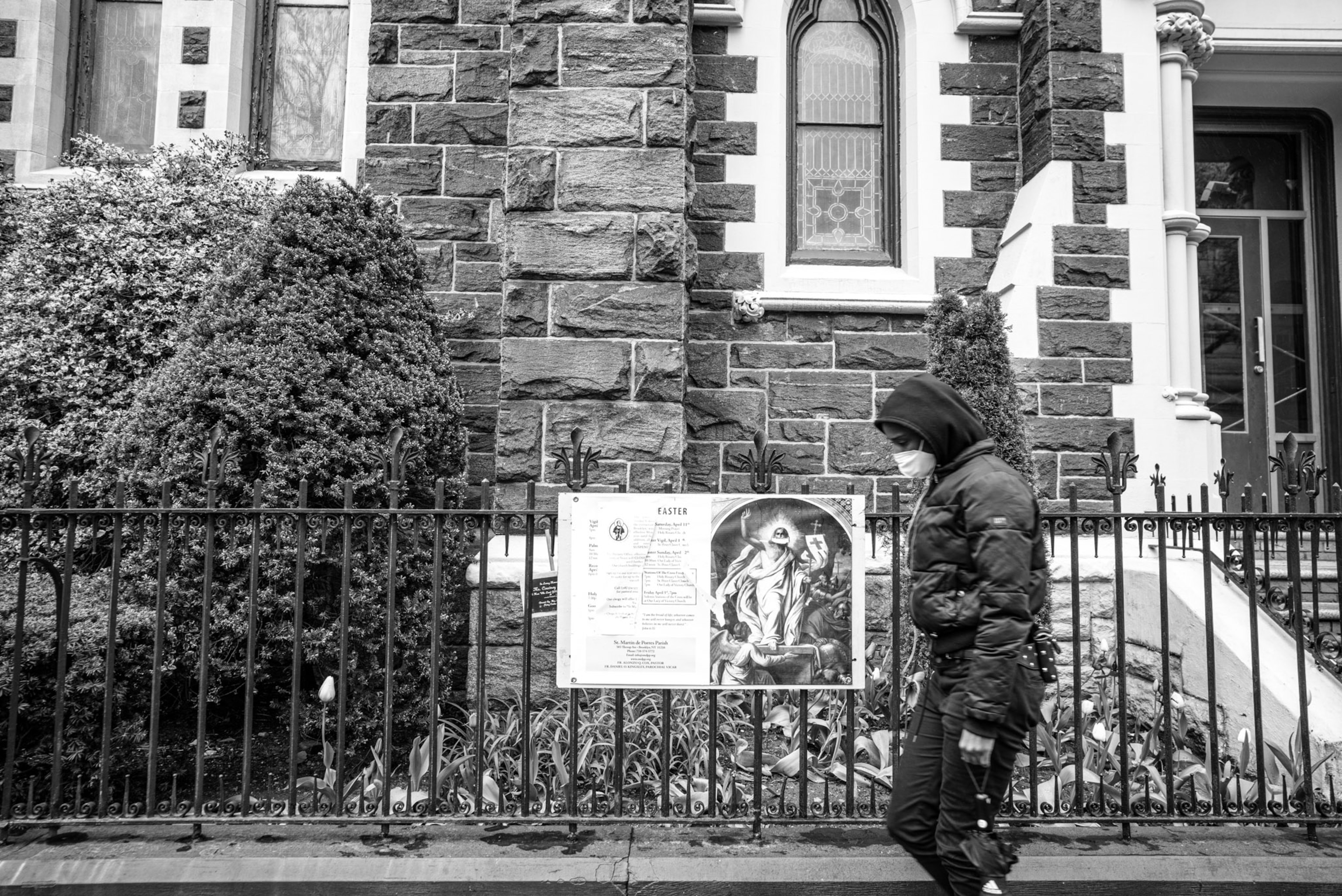 a person in a mask walking past a church