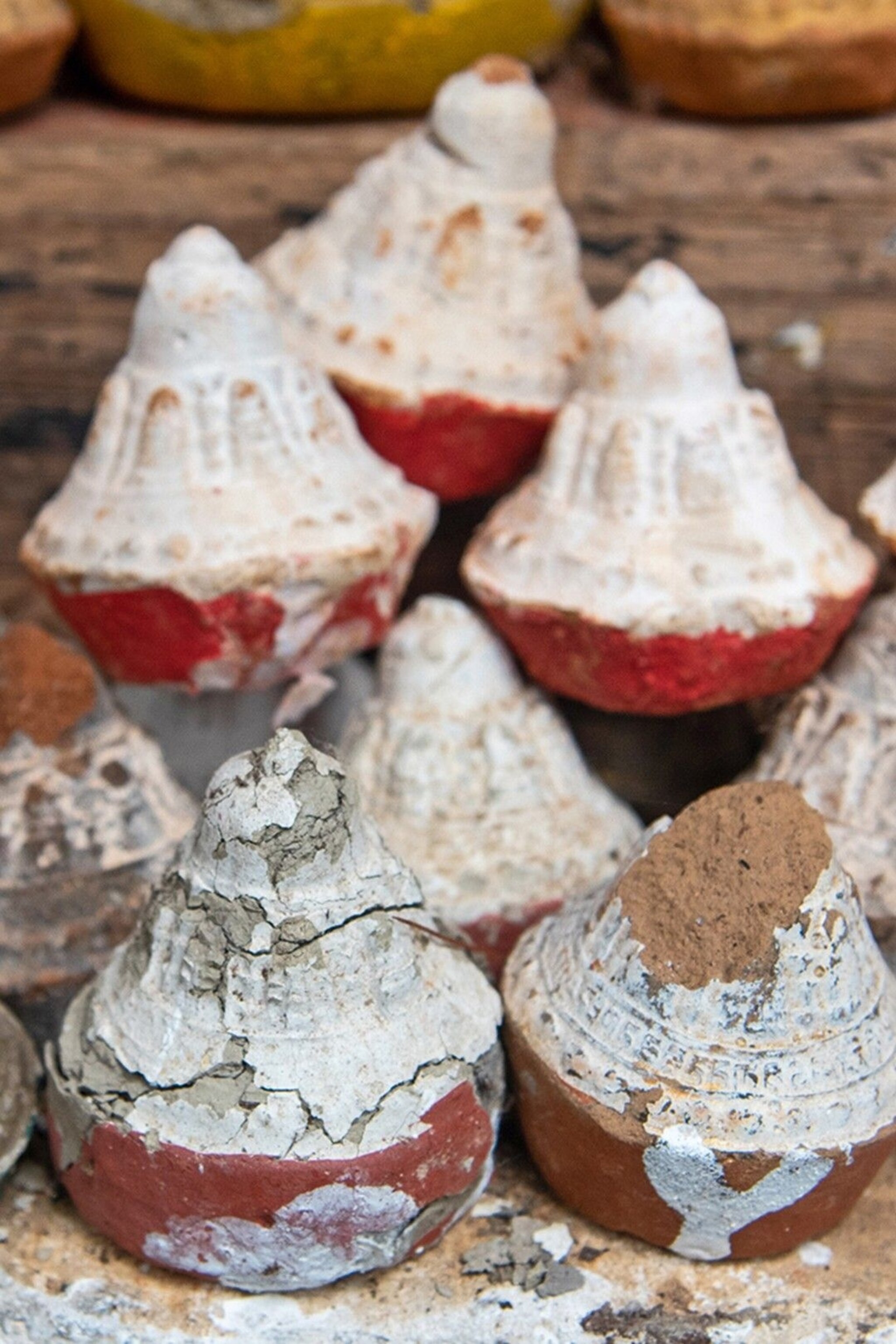Tsa-tsa cones lodged in rocky niches to commemorate departed loved ones.