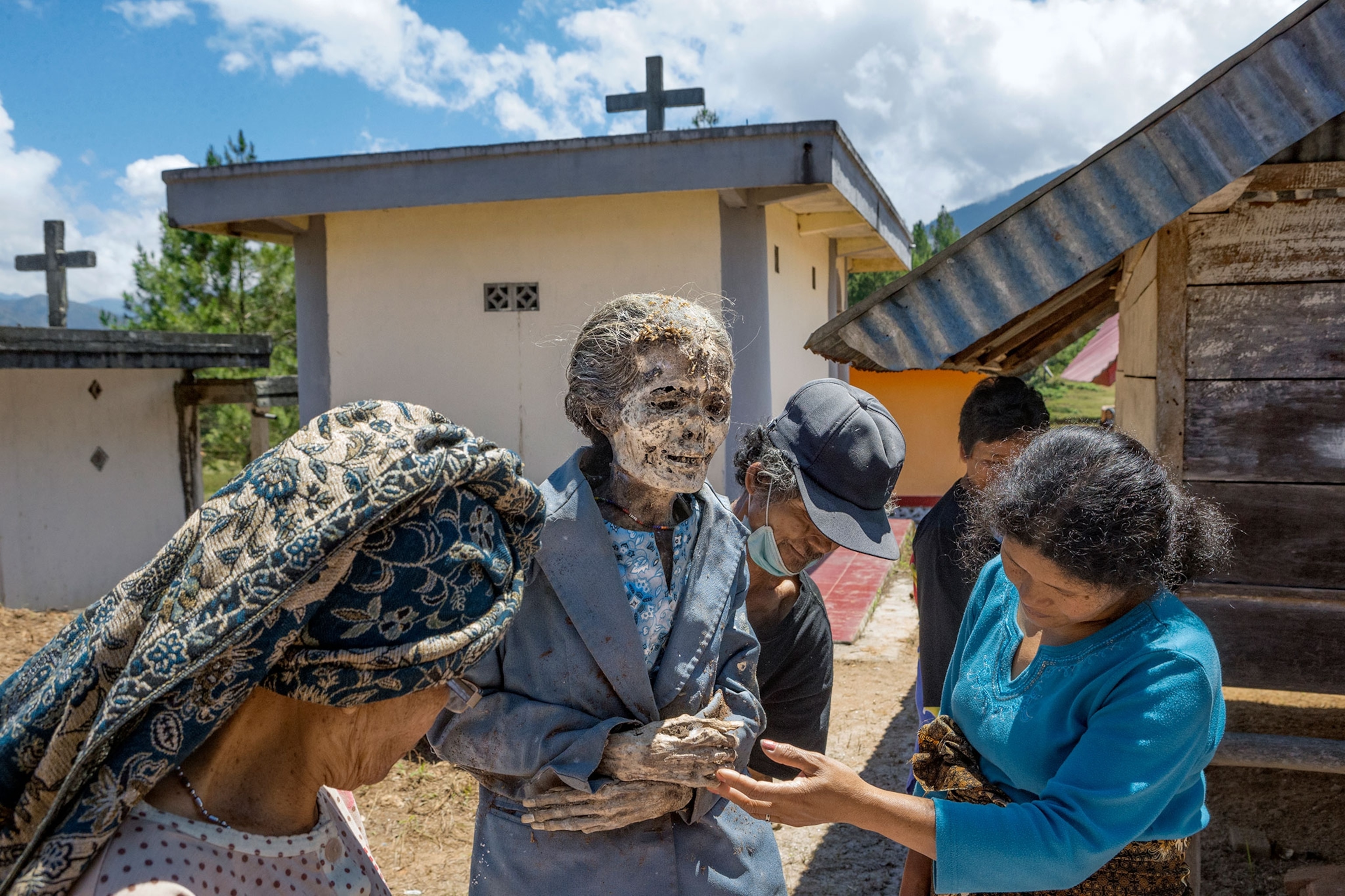 families gather to remove their relatives from graves