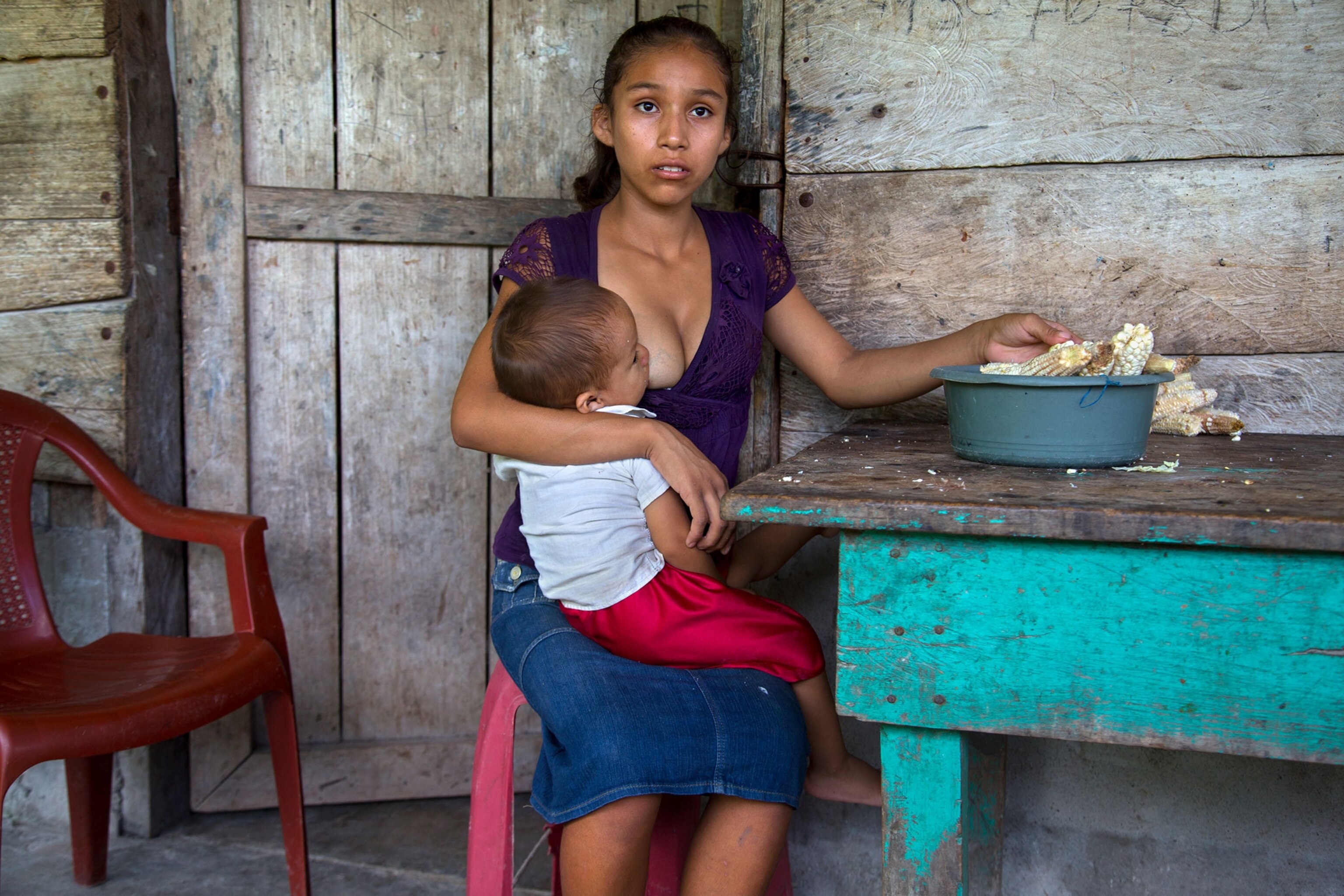 A 15-year-old girl nurses her child son in Guatemala
