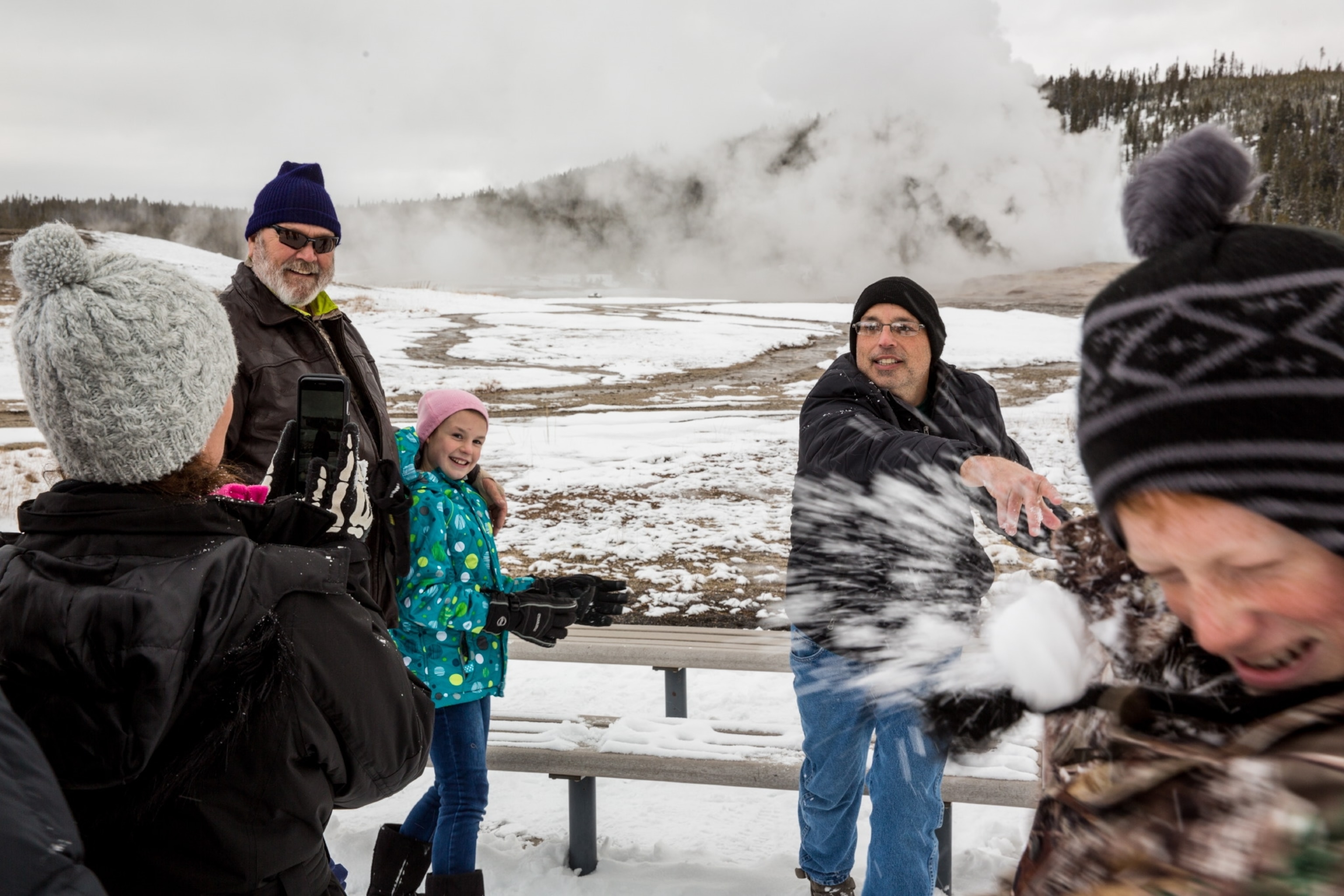 A family throwing snowballs outside