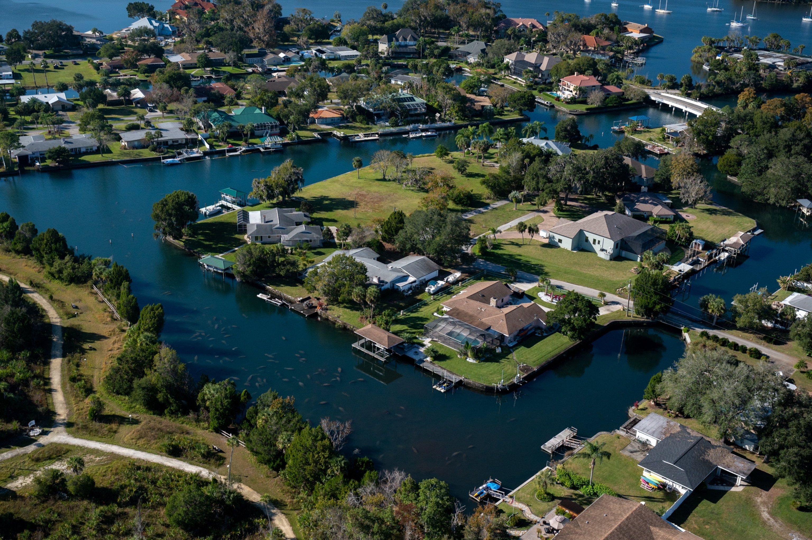 A birds eye view of a development next to a stream with manatees in it