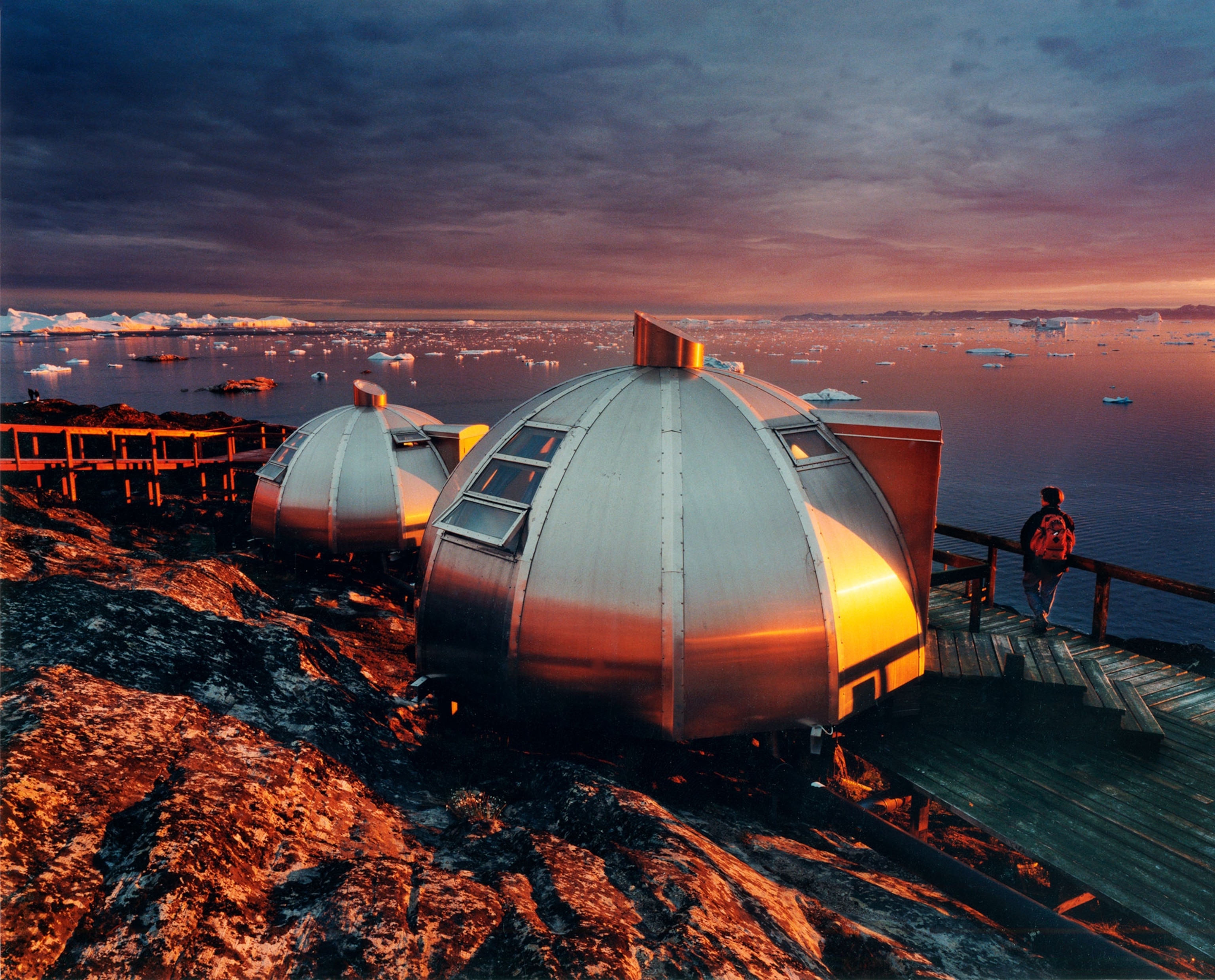 metal igloo rooms reflecting sunset
