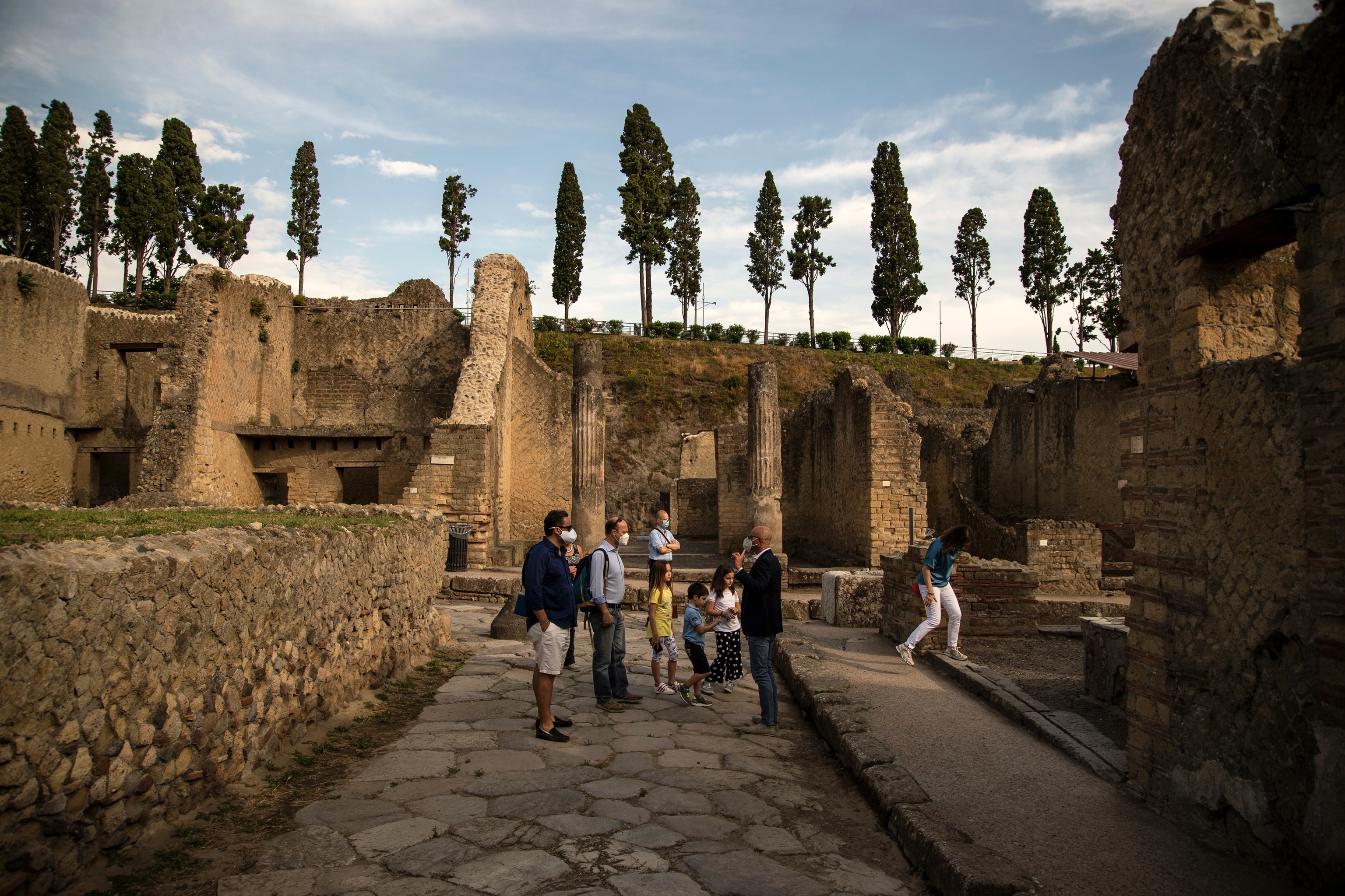Tourists visit the ruins of the ancient Roman city of Herculaneum