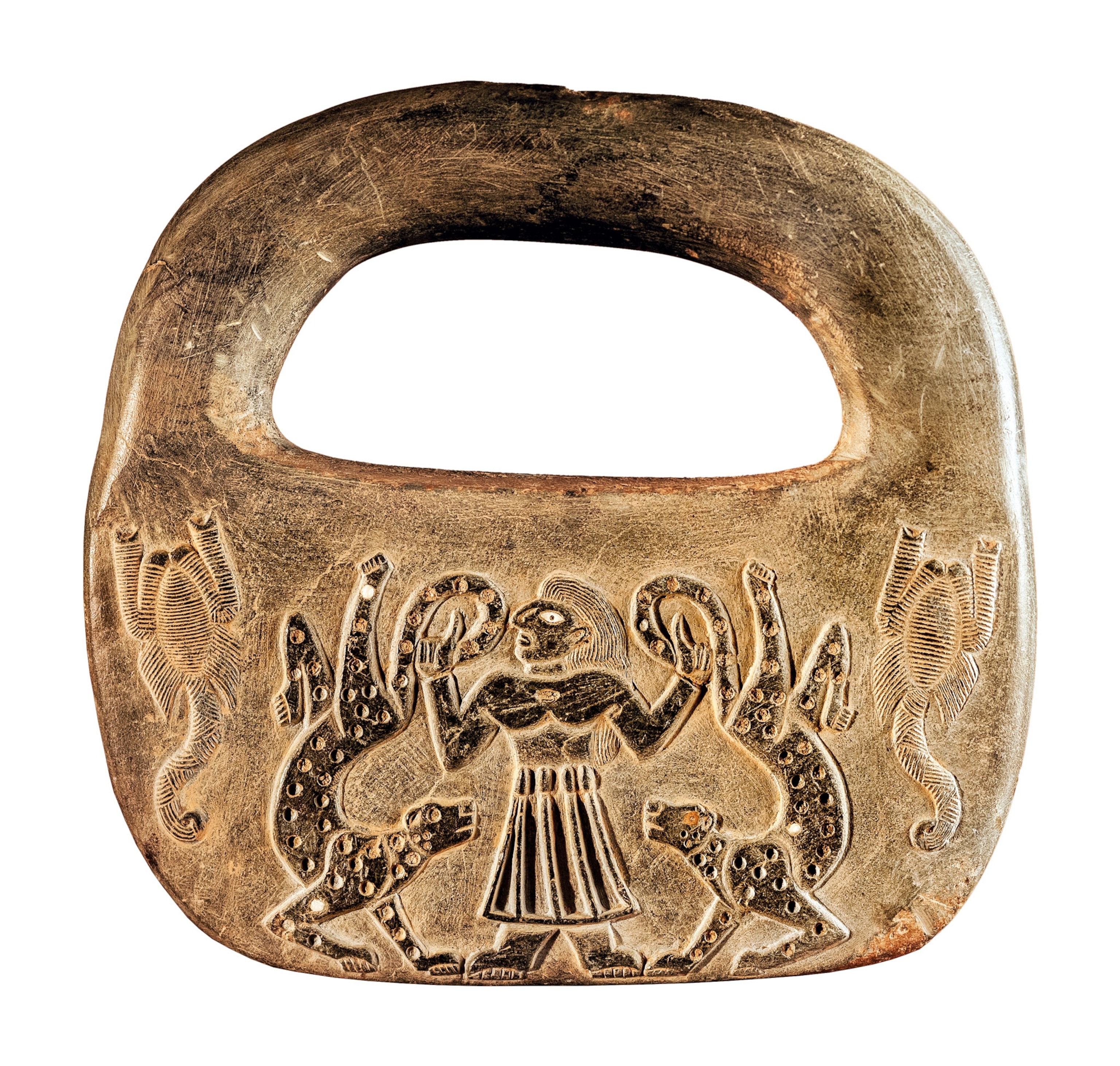 A round stone with a handle with a carving of a man and two cheetahs on it