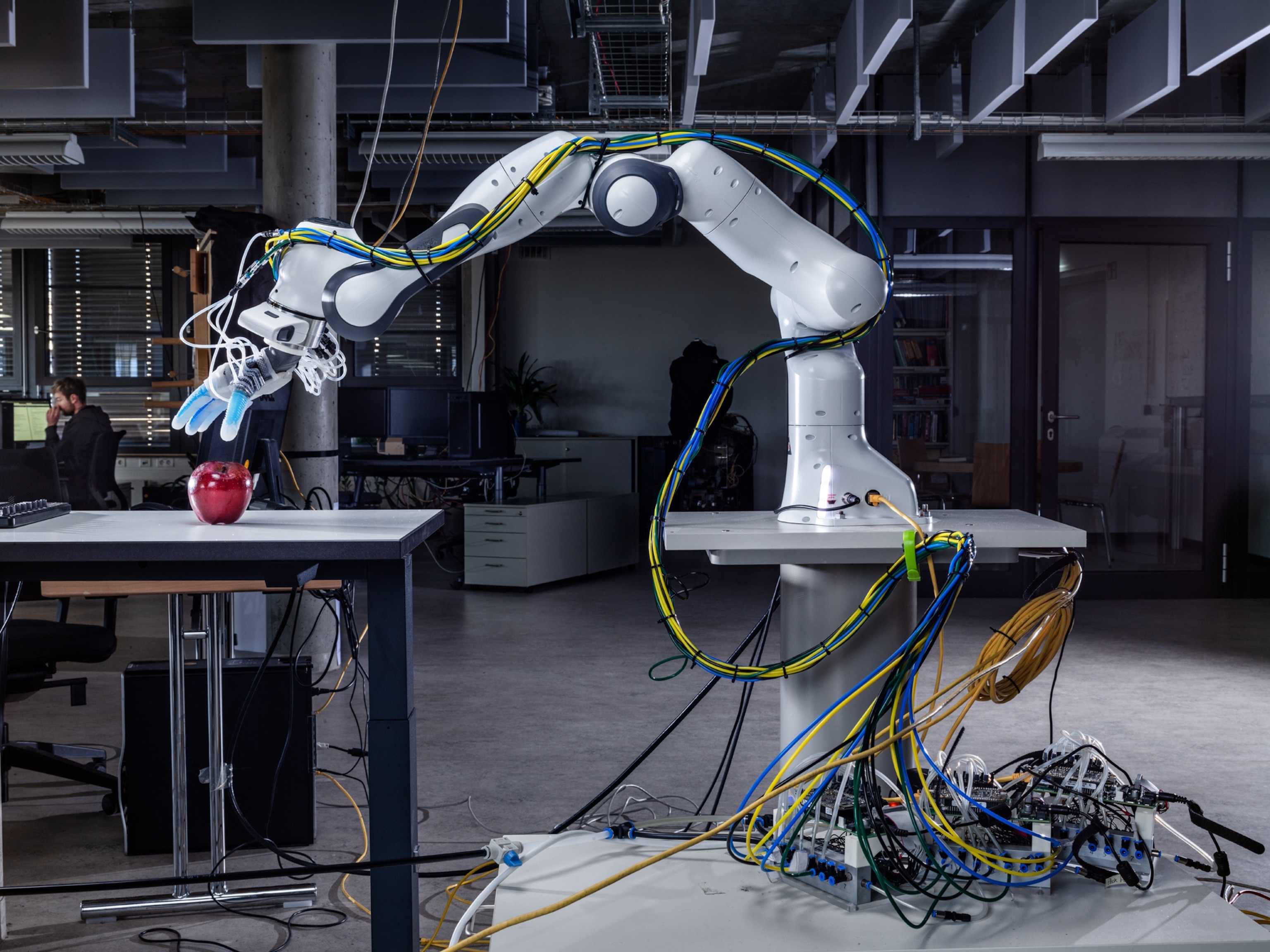 robotic hand reaching for an apple.