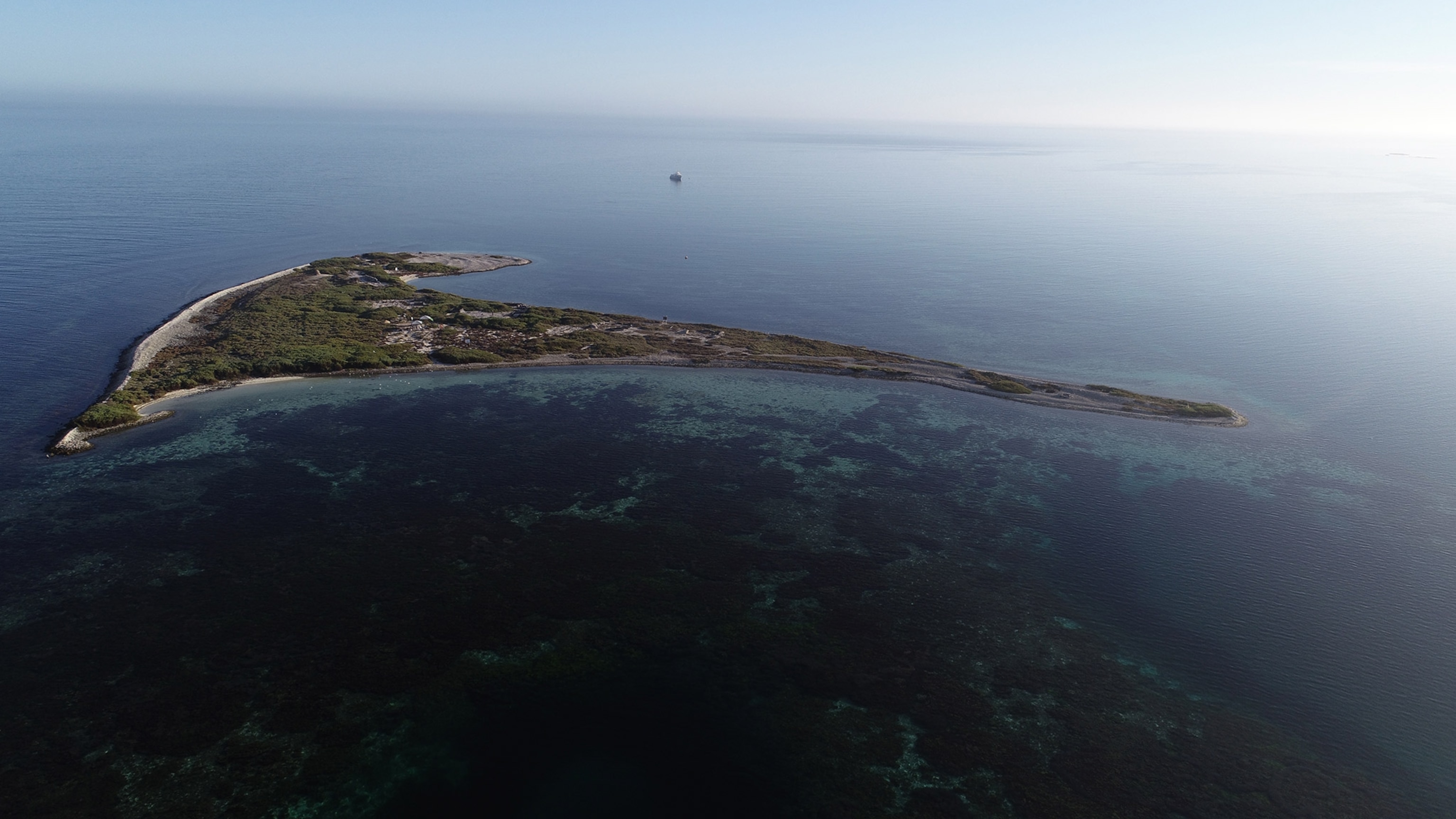 An Island from above you can sea the coast and greenery.
