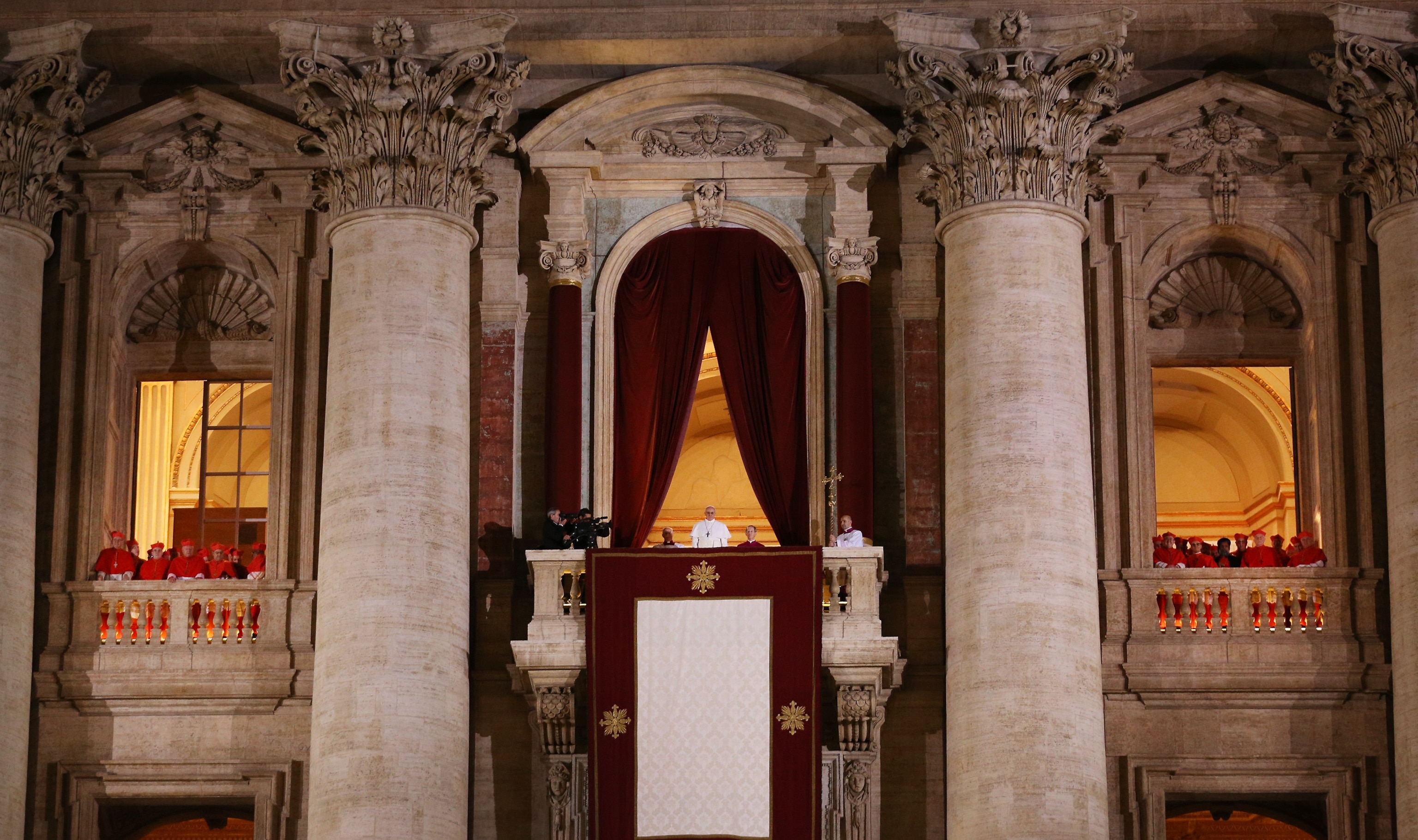 Newly elected Pope Francis I appears on the central balcony of St Peter's Basilica