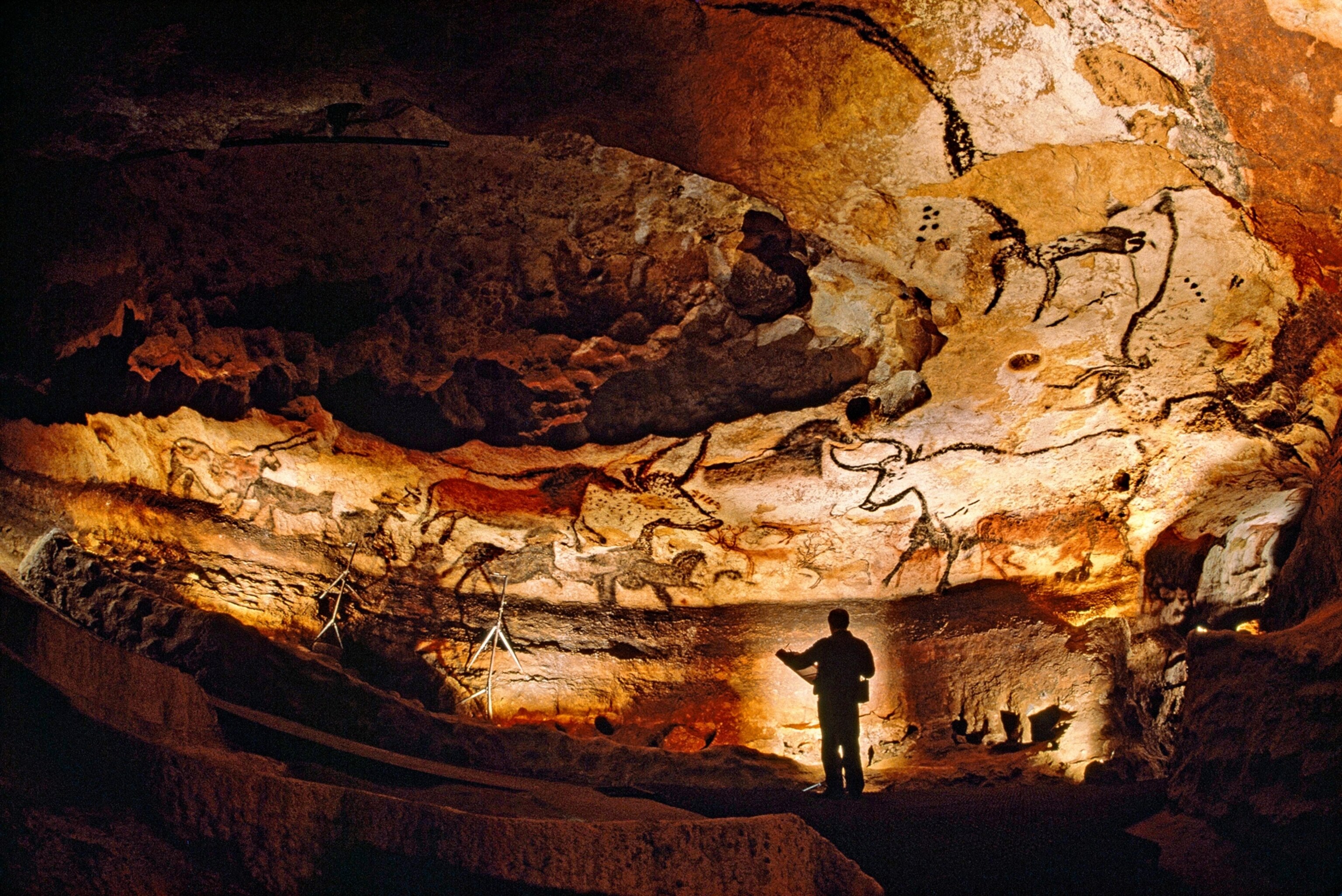 Picture of rock art on lit cave wall.