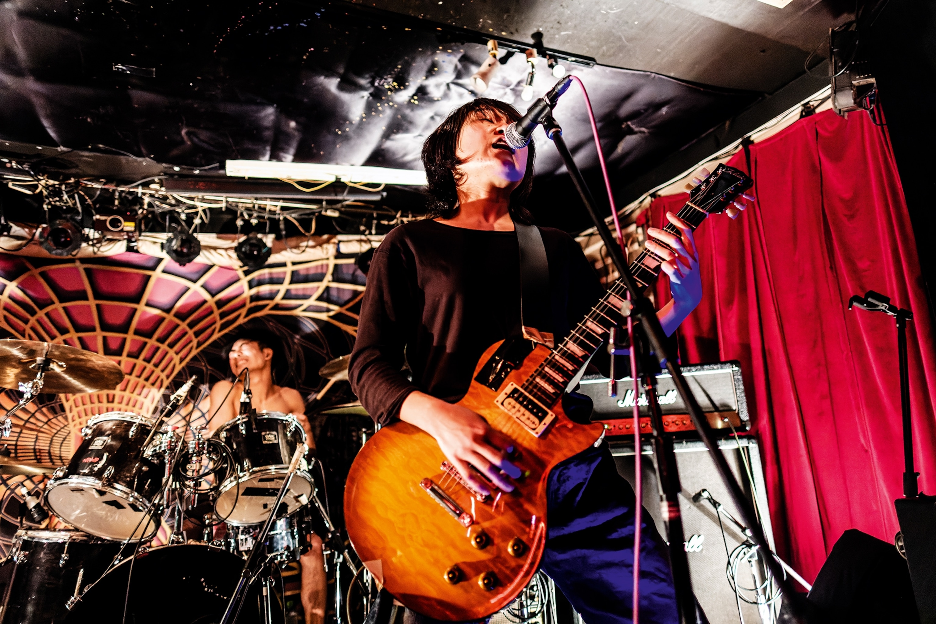 A live performance from Japanese hardcore pink band Roccon at Socrates dive bar.