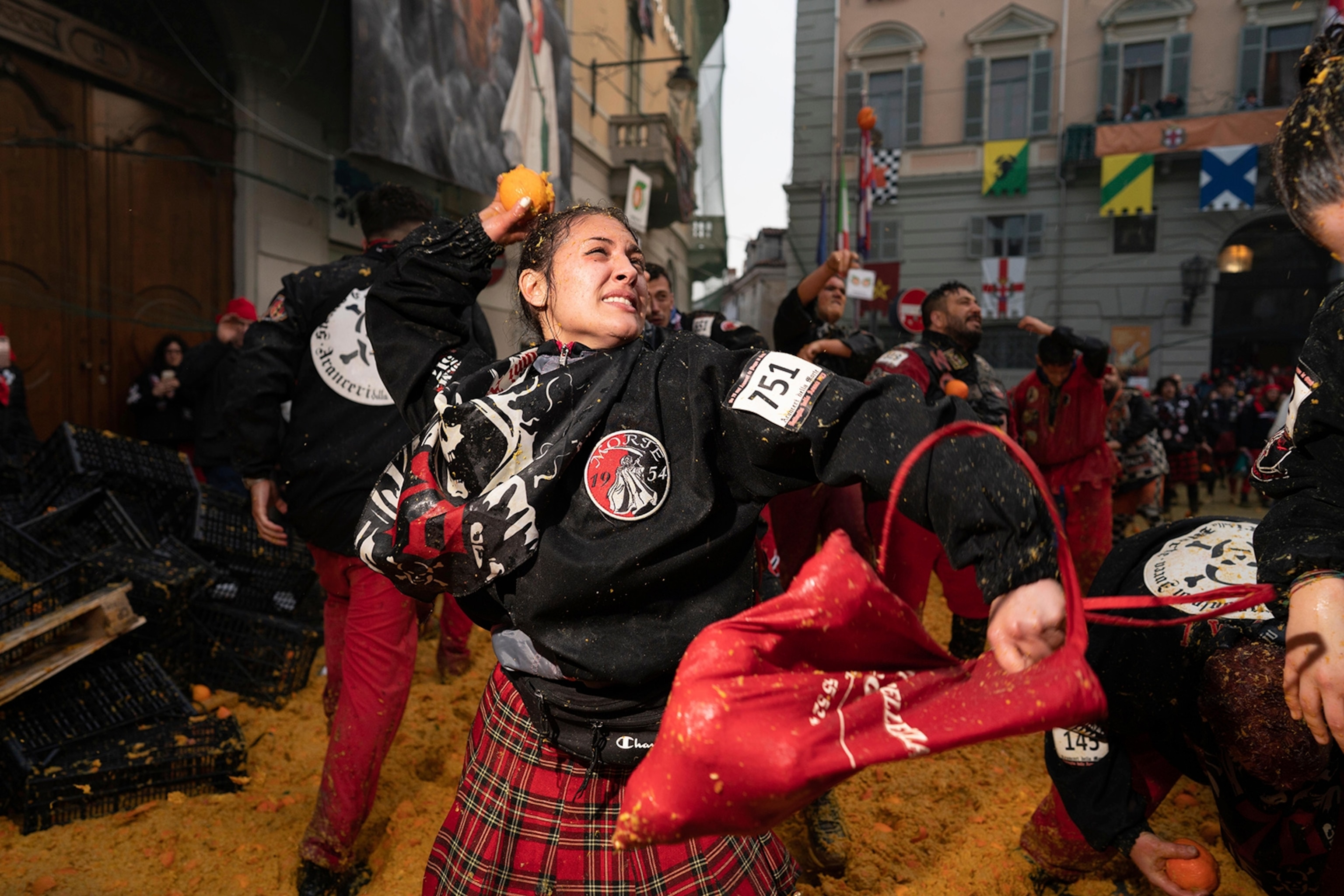 Aranceri of team Morte ( Death) challenge the carriages in Piazza di Città (Ivrea's main square).