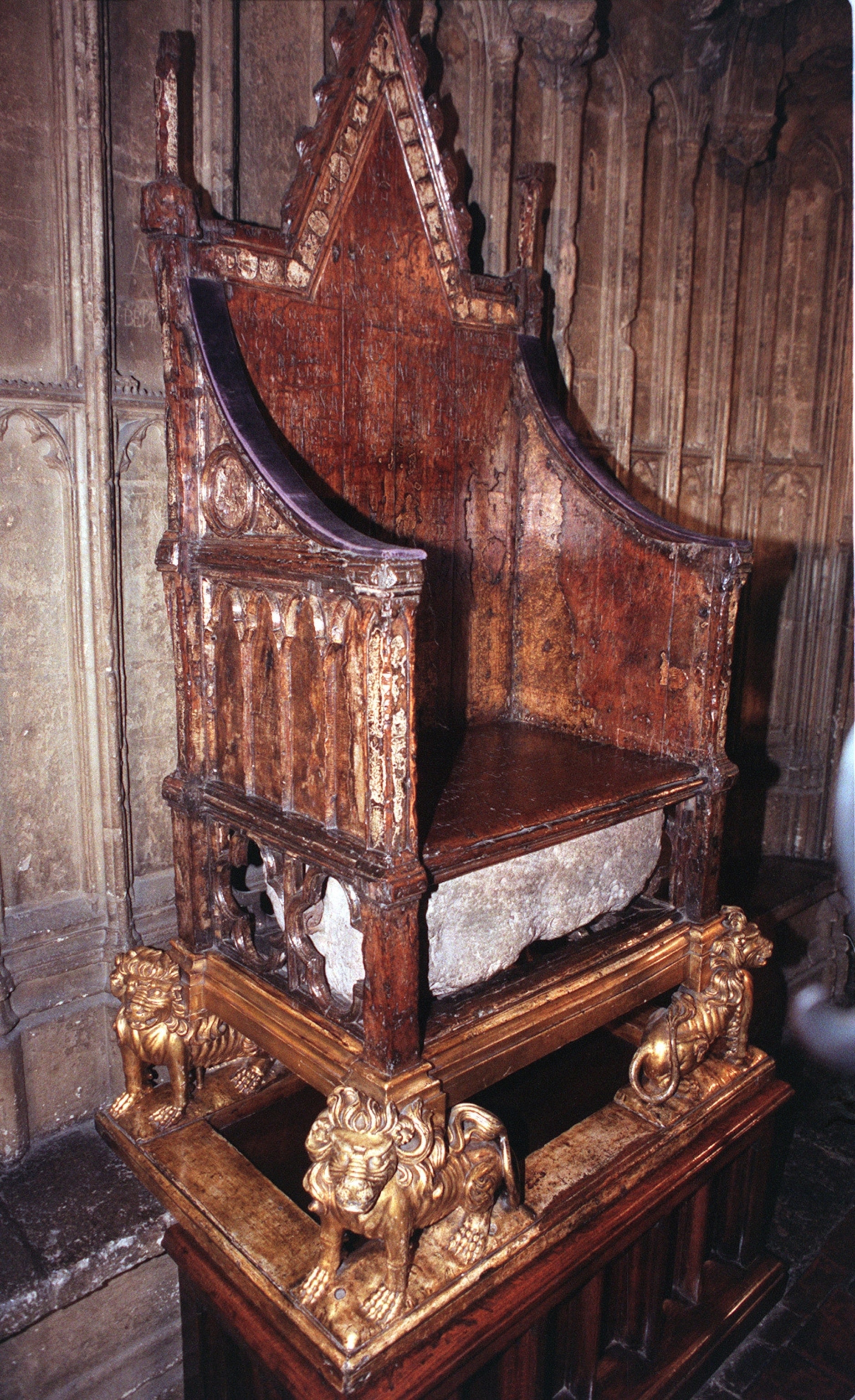 Photo of ornate wooden chair with stone slab at bottom