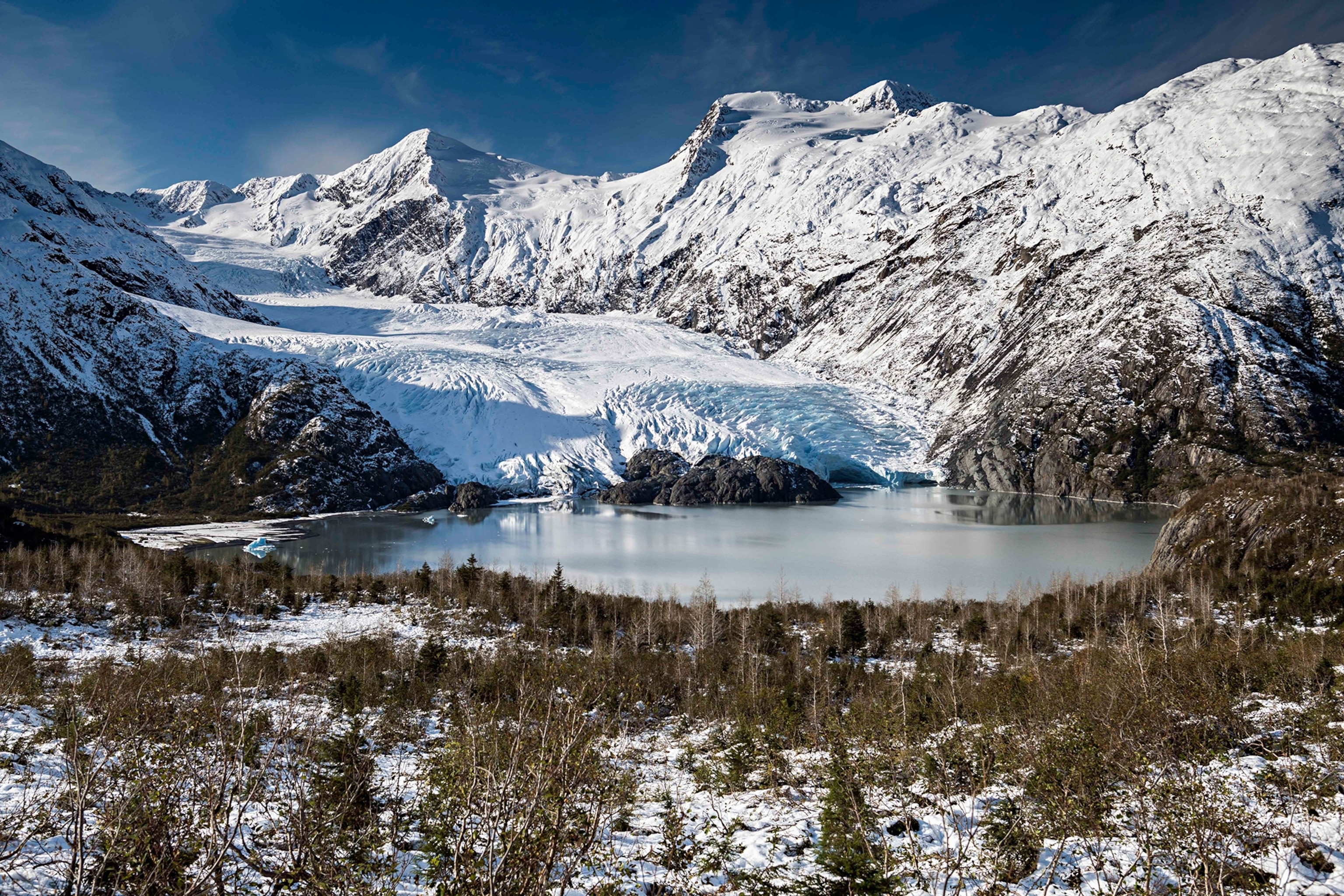 The Portage Glacier flows into Portage Lake after the first snow of the year, in Whittier, Alaska.