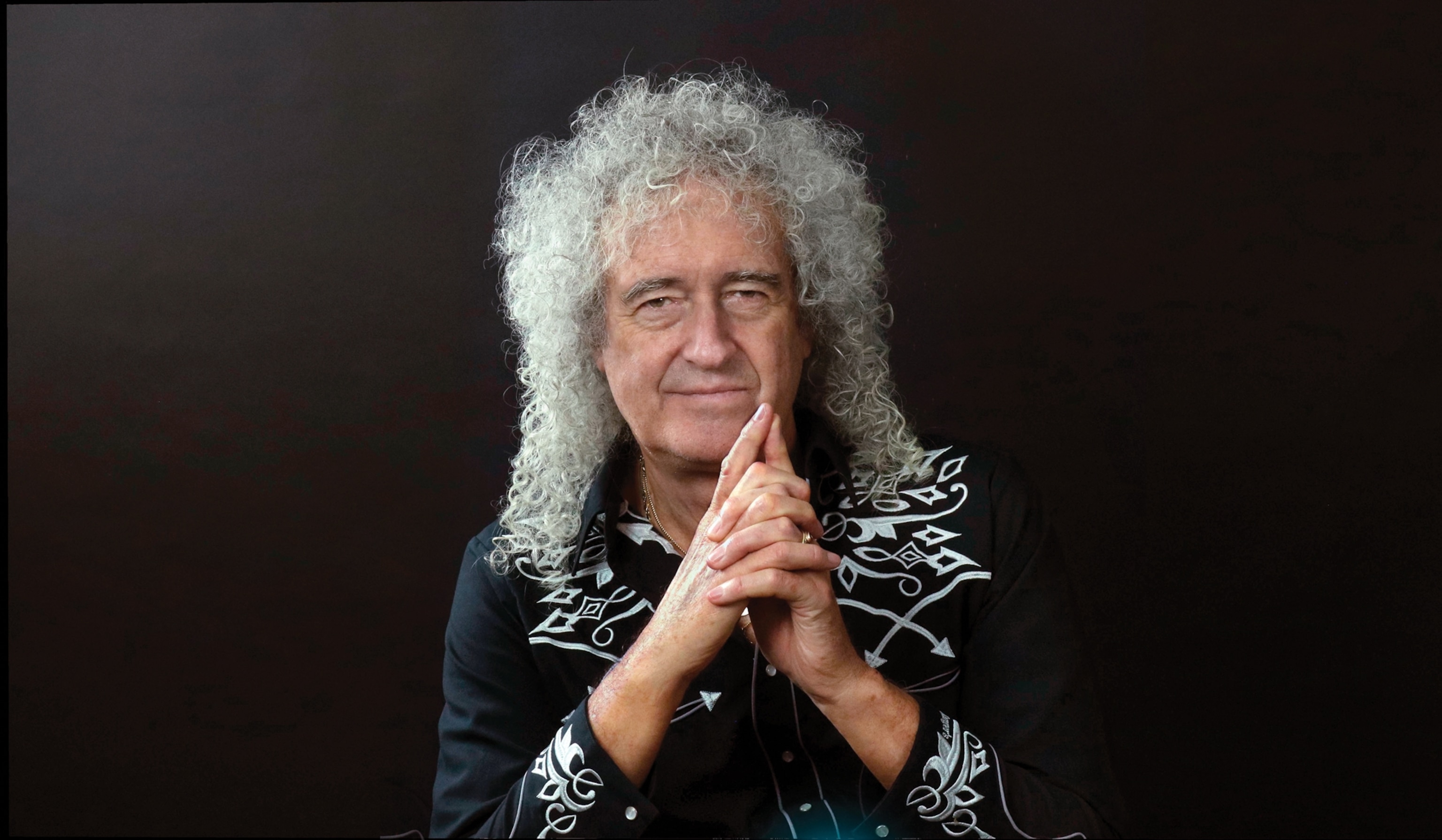 Portrait of a man with long grey hair.