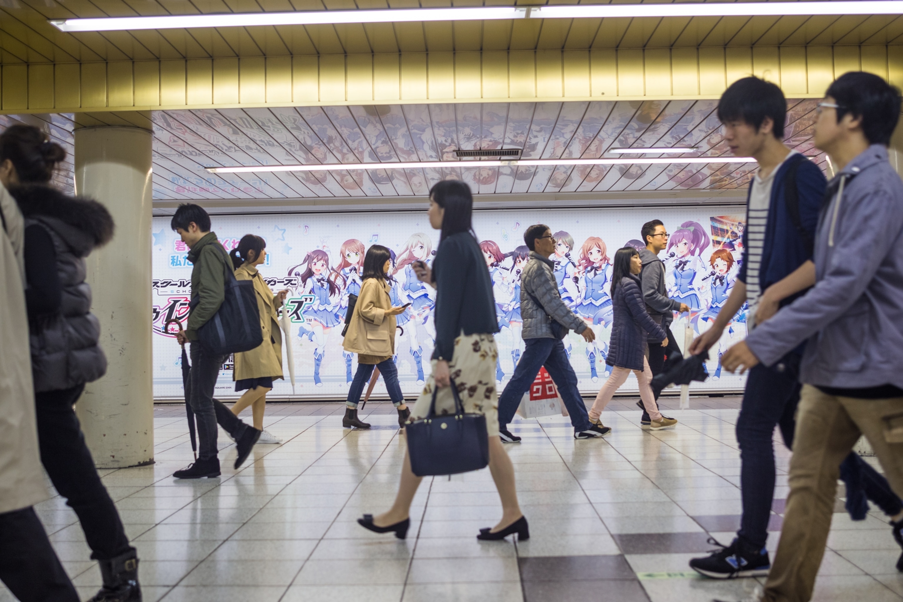 people walking in a subway station in Japan