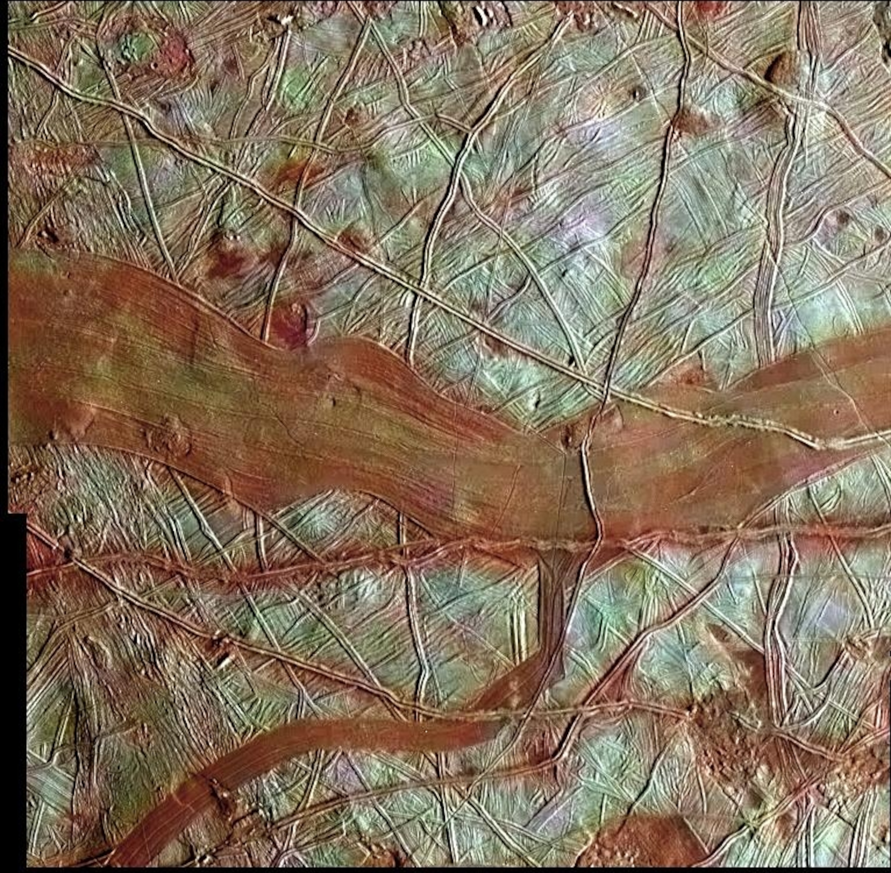 The large, ruddy smear in the middle of this image from the Galileo spacecraft is an example of a dilational band, where new ice is being pushed through cracks in Europa's crust. (NASA/JPL-Caltech/SETI Institute)