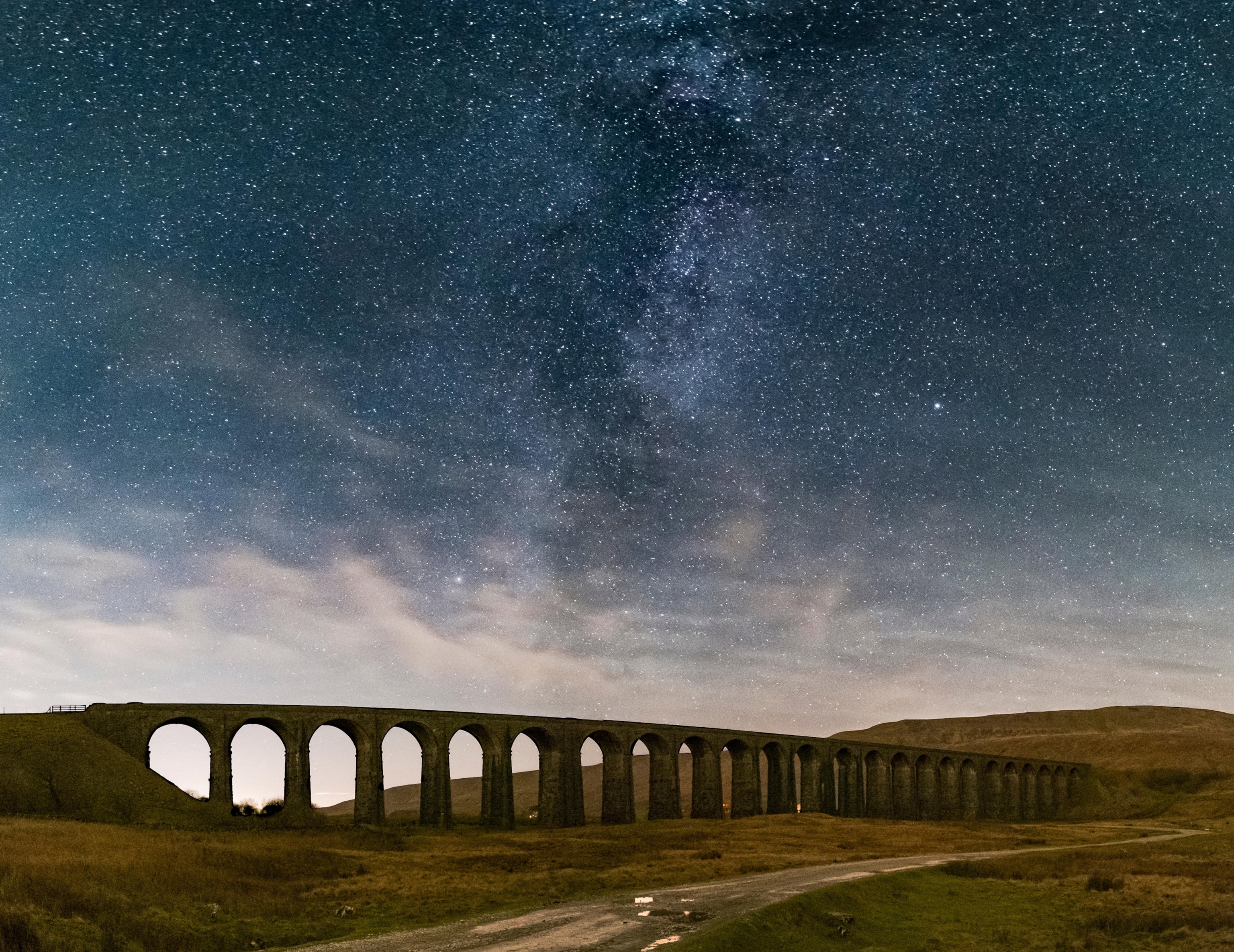 A viaduct seen under a starry sky