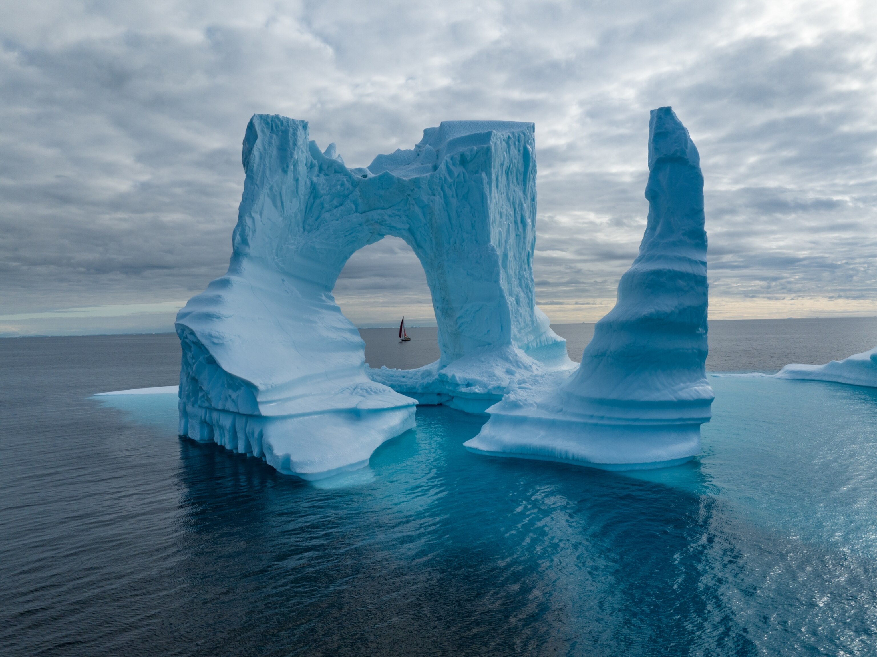 a sail boat passes the eye of the